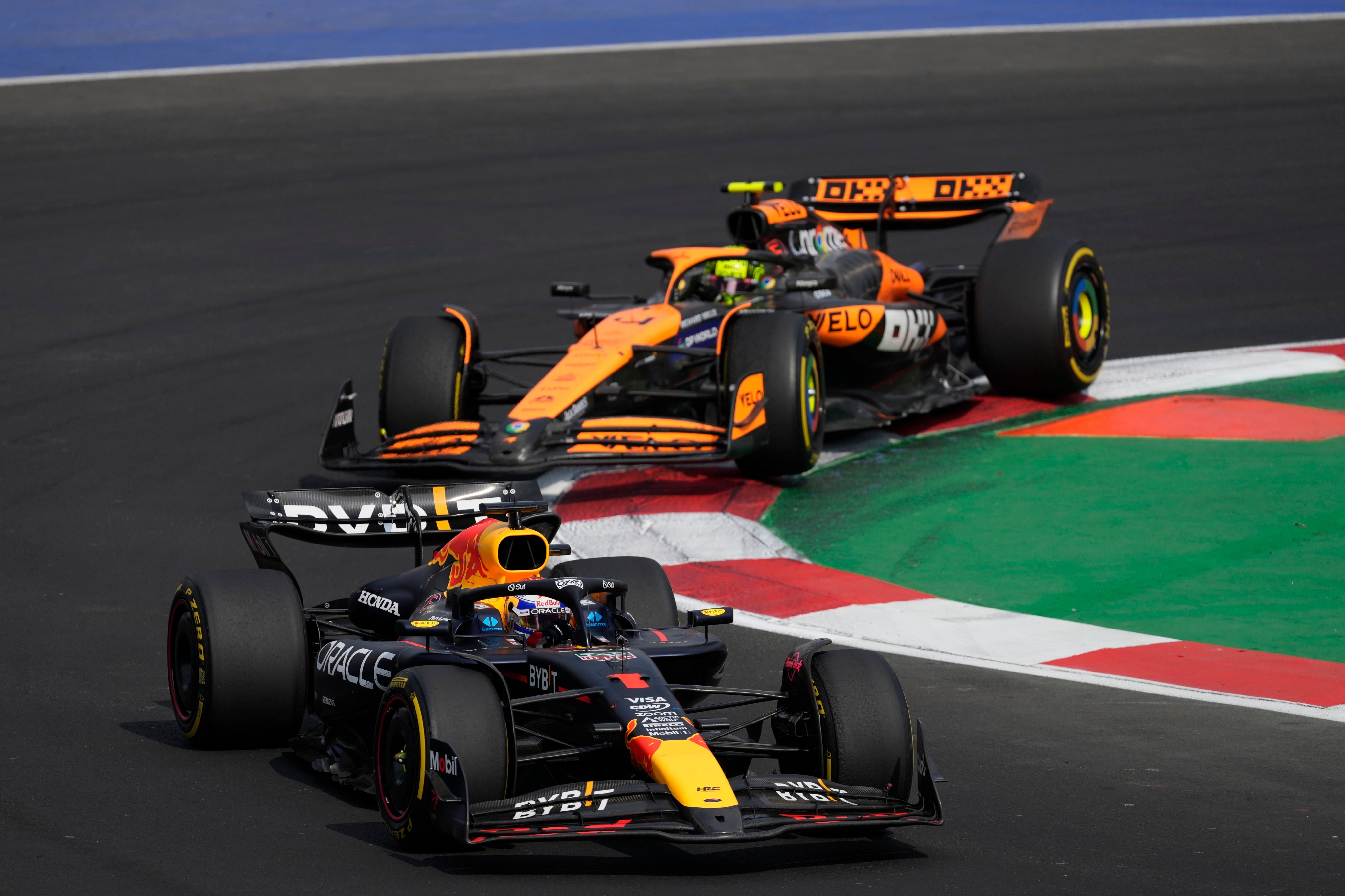 Max Verstappen, seen here fighting to stay ahead of Lando Norris, was penalised twice for his driving during the early stages of the Mexican Grand Prix. Photo: AP