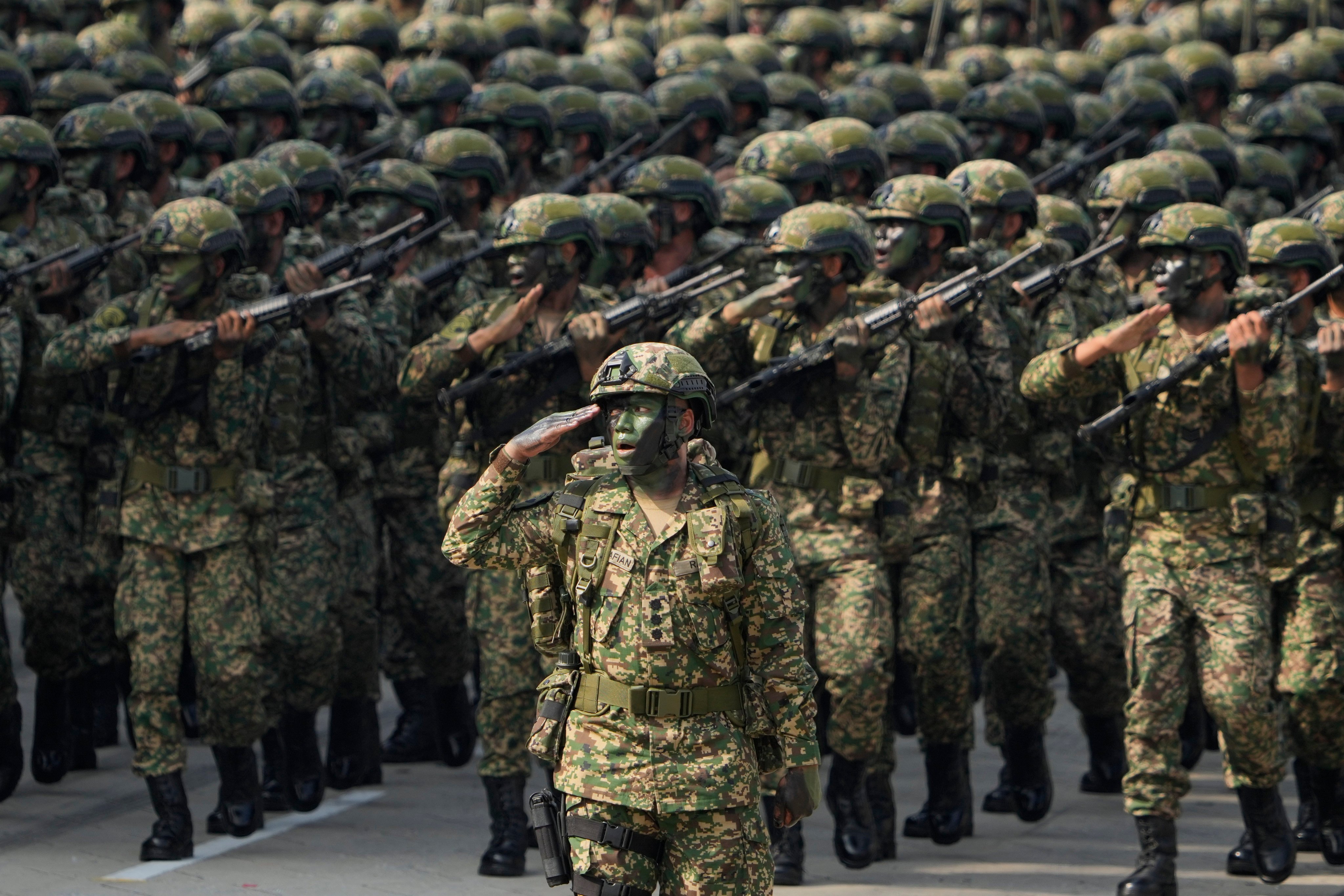 Royal Malaysia Army march in formation during National Day celebrations at Independence Square in Kuala Lumpur, Malaysia. Photo: AP