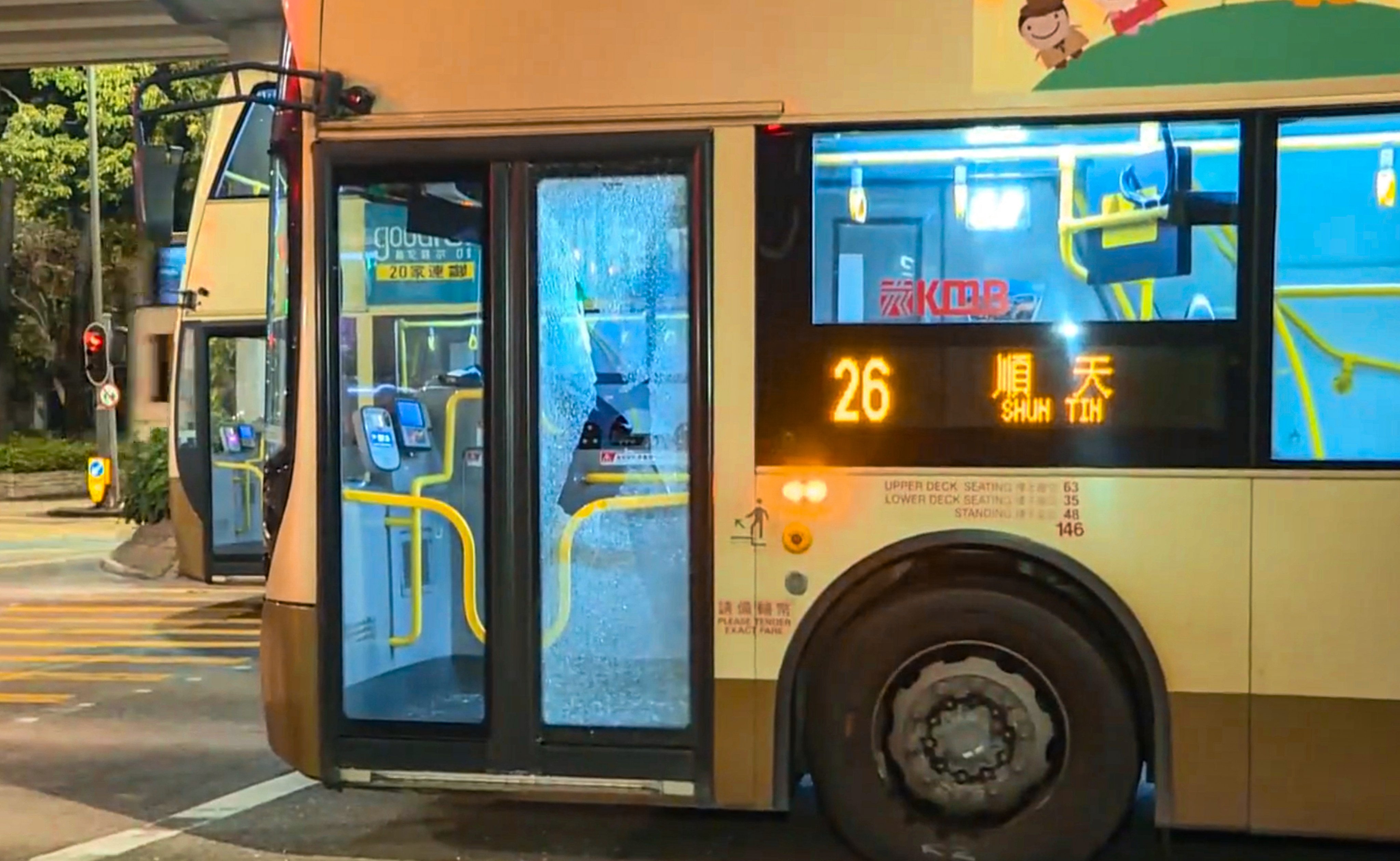 A passenger has shattered the glass panelling of a KMB bus door in a fit of rage after the driver failed to pick him up at a bus stop. Photo: i-Cable TV News