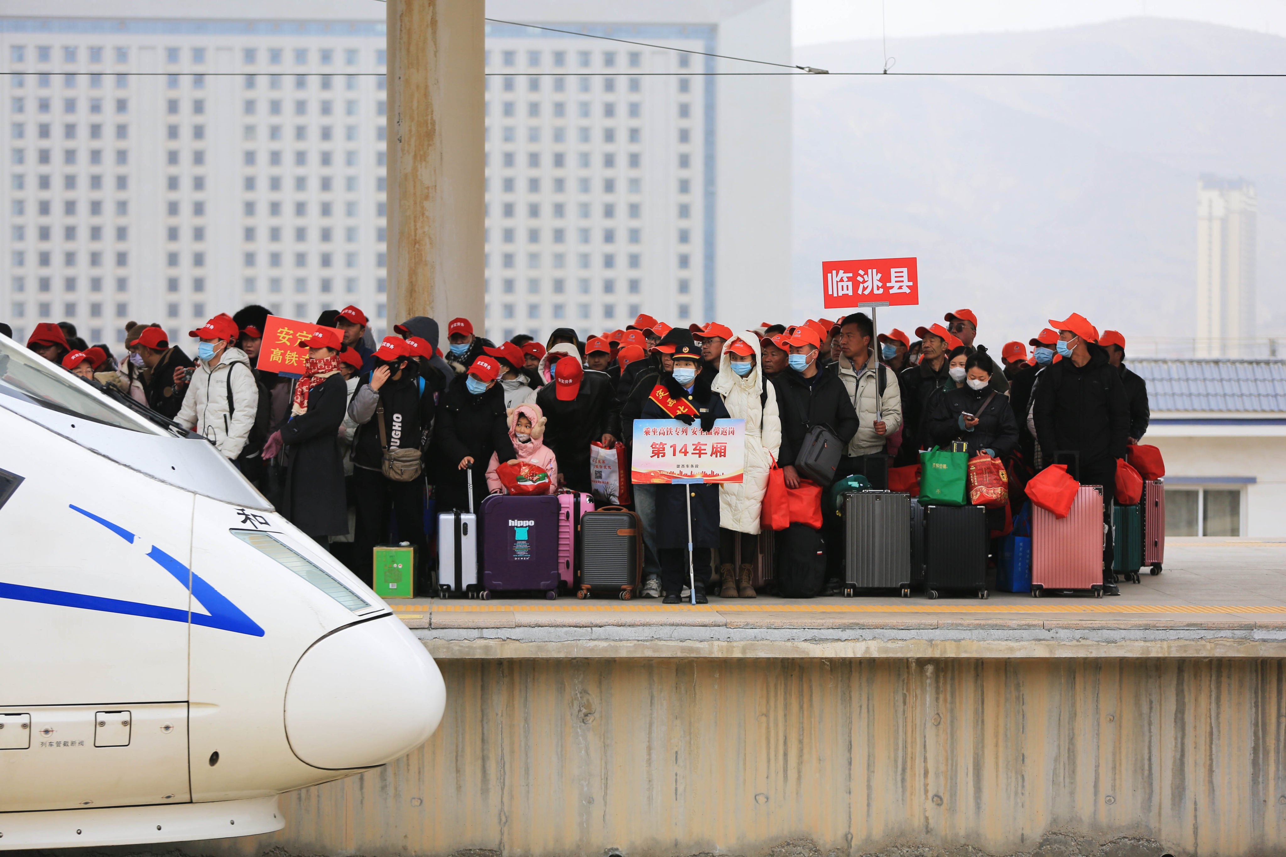  Migrant workers wait to board a train at Dingxi North Railway Station in Dingxi, Gansu province, on February 19. Photo: Xinhua