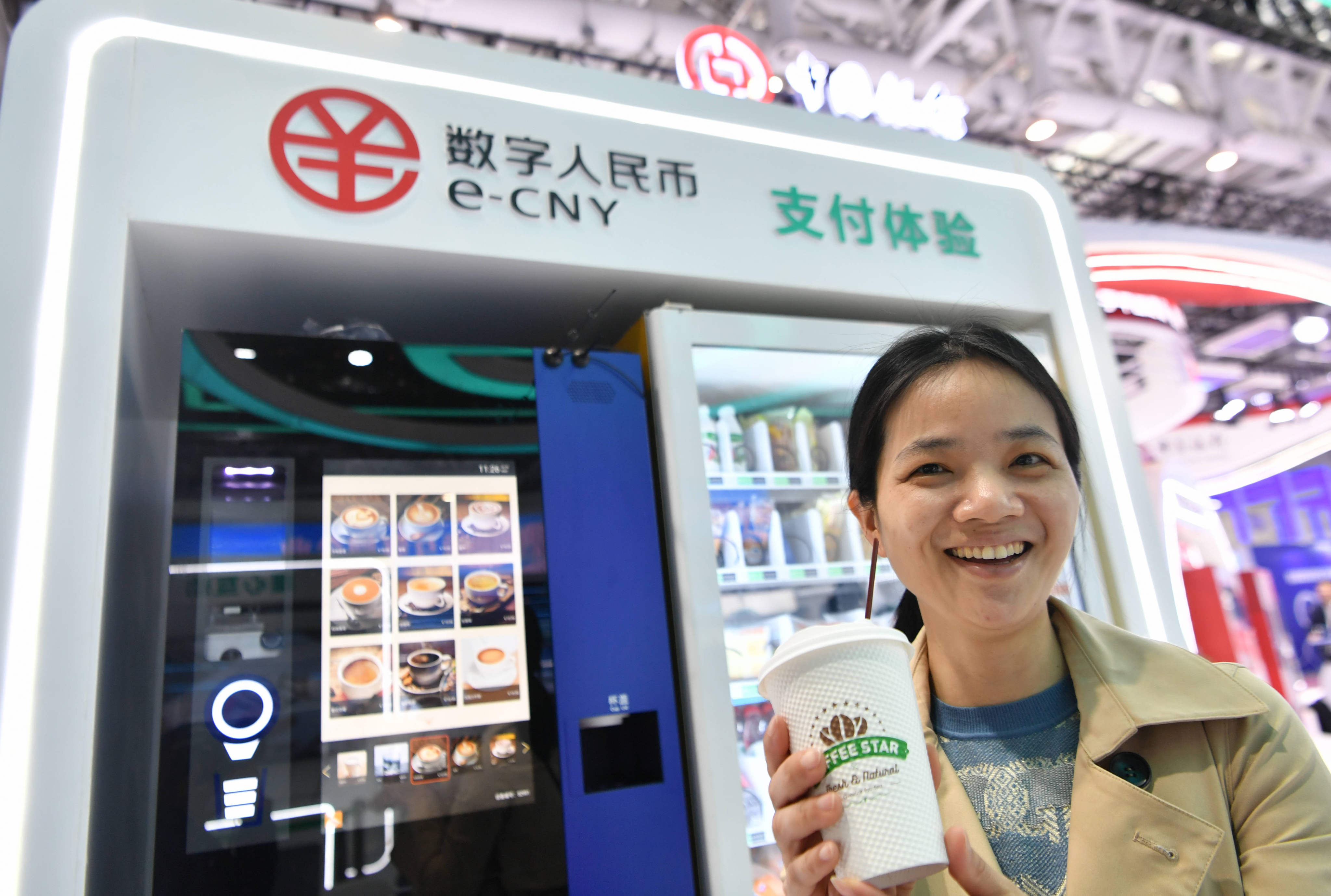 A visitor displays a cup of coffee bought with China’s digital yuan, or the e-CNY, at the Digital China Summit in Fuzhou, Fujian province, on April 26, 2023. Photo: Xinhua