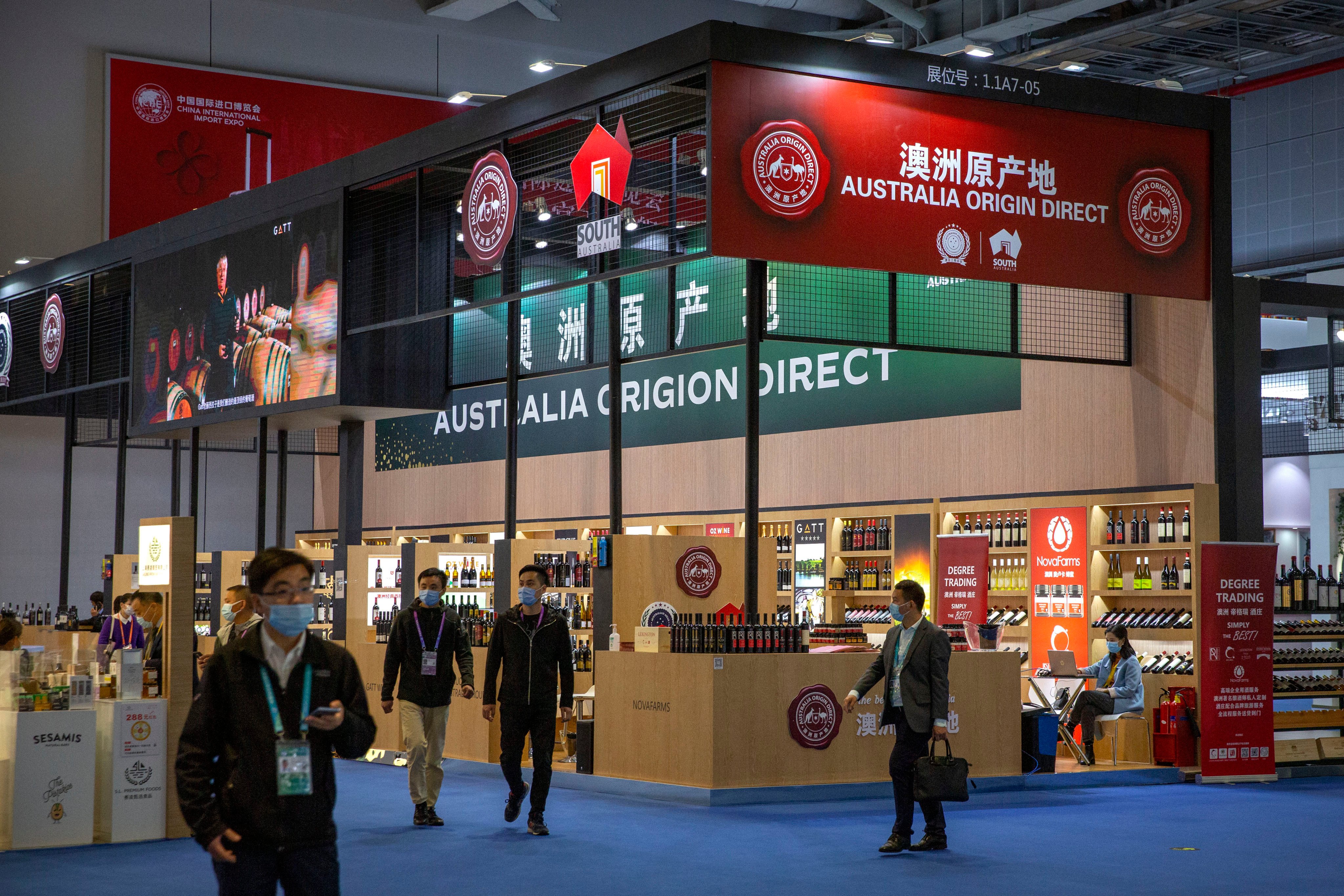 Visitors wearing face masks walk past a display of Australian wines and other agricultural products at the China International Import Expo in Shanghai in November 2020. Photo: AP