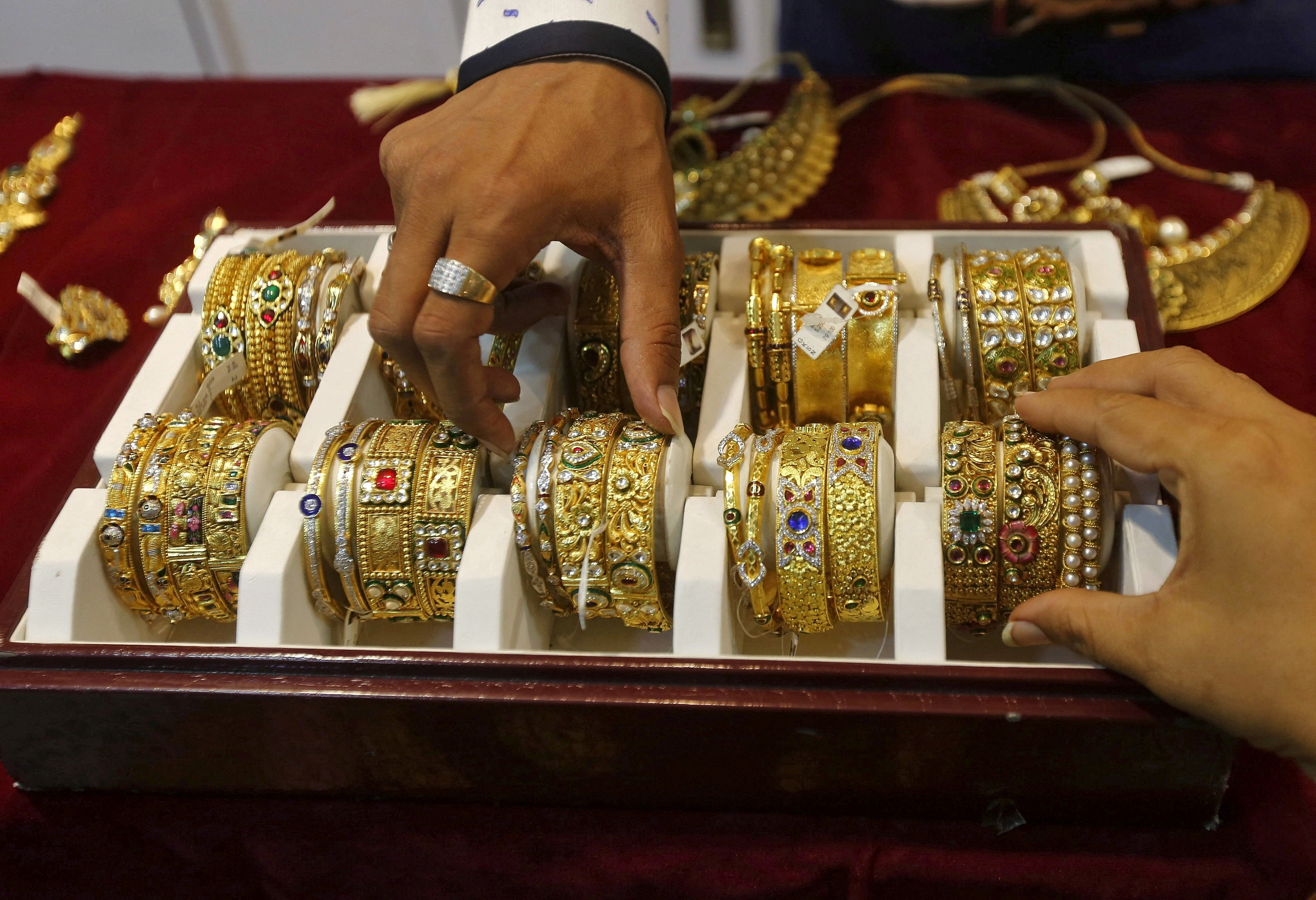 A salesman helps a customer select gold bangles at a jewellery showroom in Mumbai. Gold prices near record highs, driven by US election uncertainty, are dampening India’s peak festival gold buying season, with sales down 10-20 per cent. Photo: Reuters