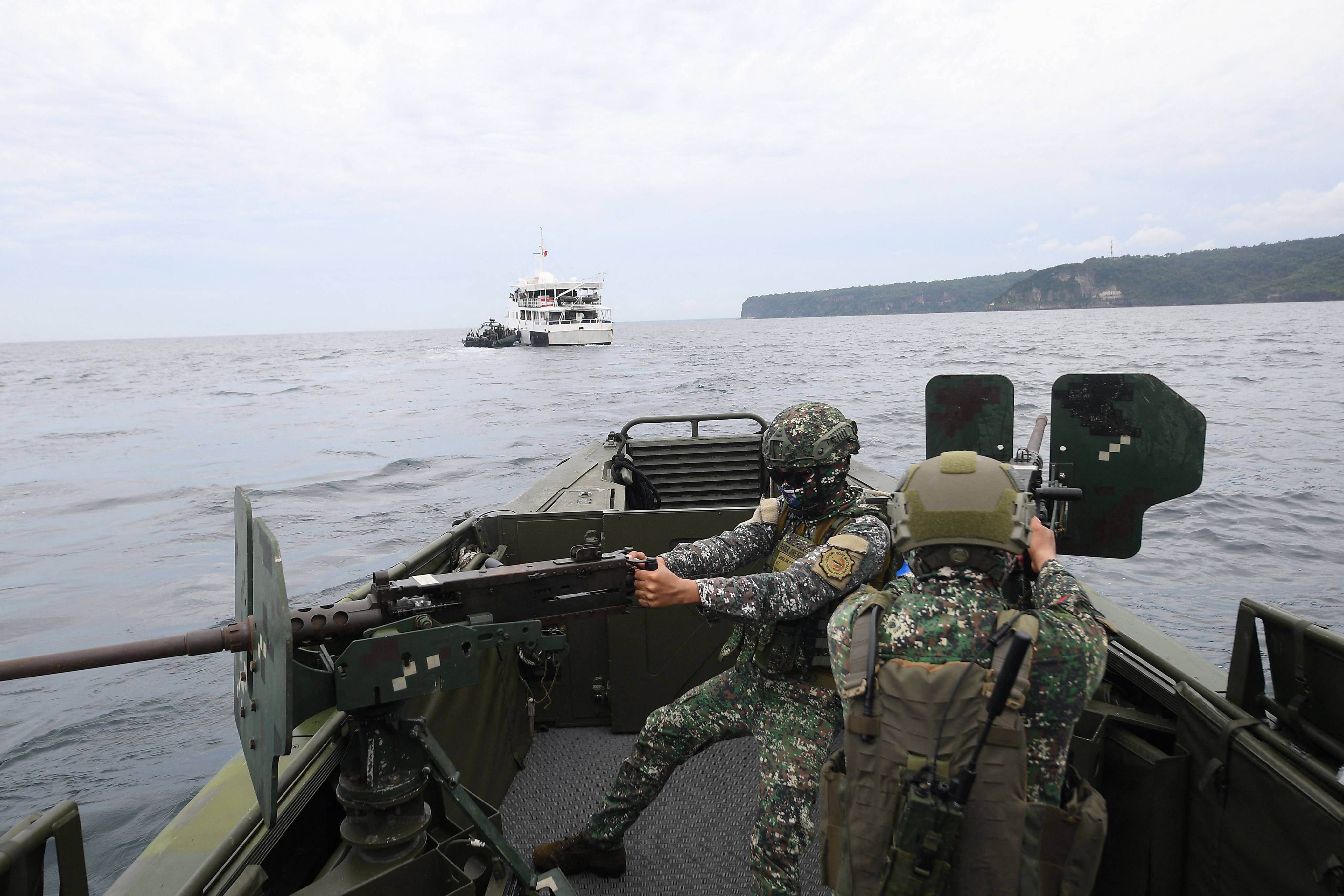 Philippine marines aboard their patrol boat man machine guns during a joint exercise with their US and South Korean counterparts in Cavite province west of Manila on Tuesday. Photo: AFP 