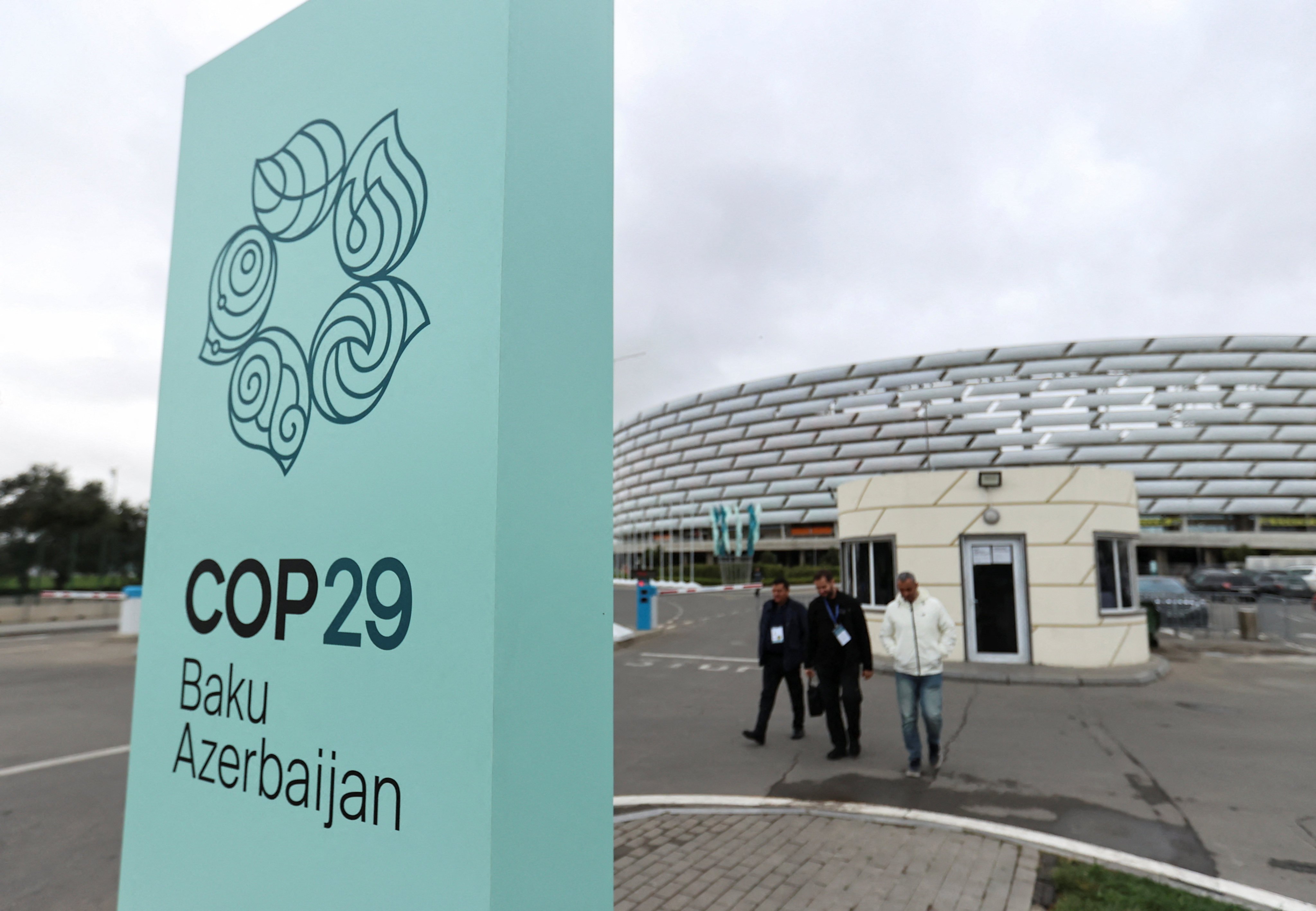 People walk near the Baku Olympic Stadium, the venue of the Cop29 UN climate change conference, in Baku, Azerbaijan, on October 18. Photo: Reuters