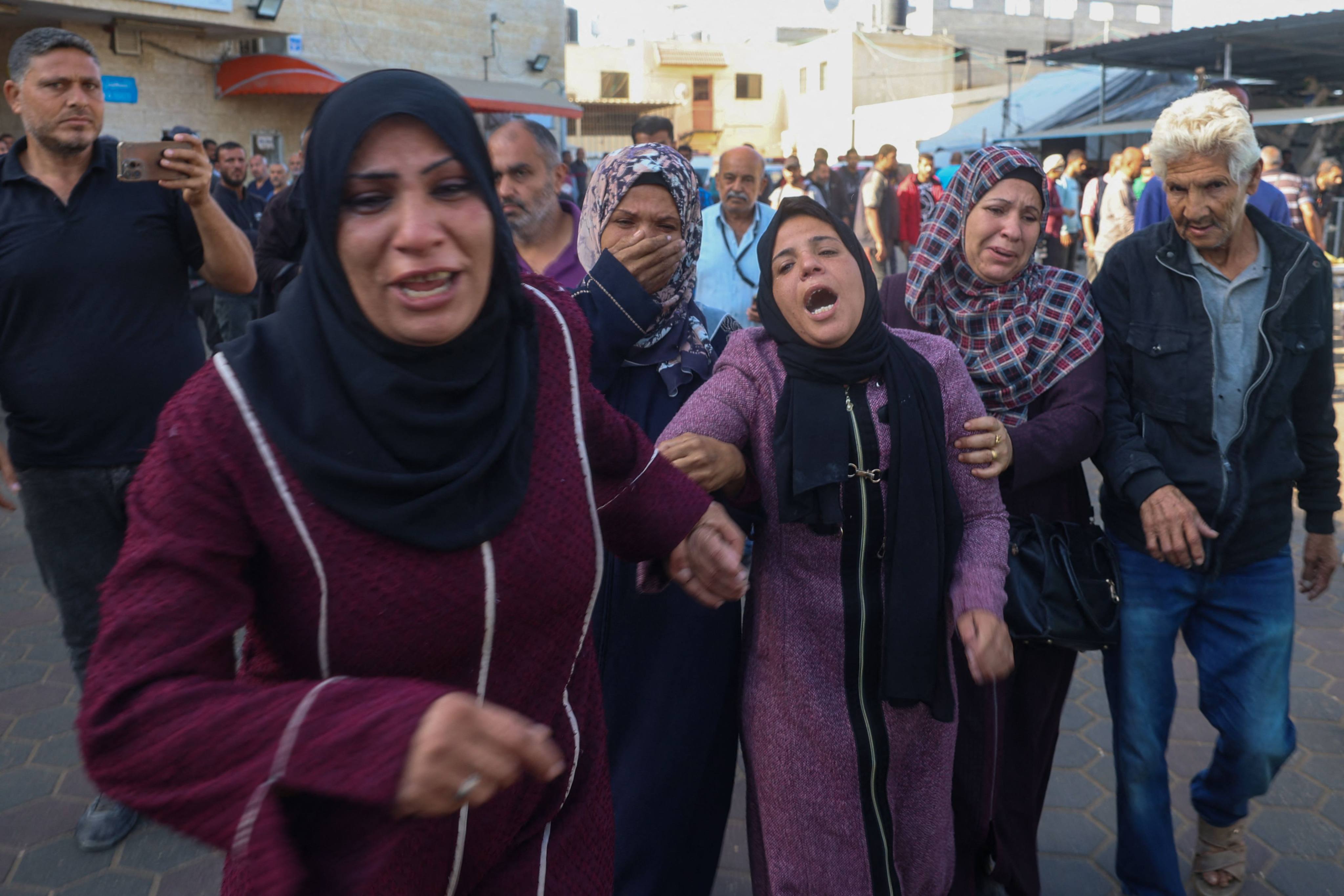 Family members mourn the death of Palestinian children who were killed in the Israeli bombardment of al-Zawaydeh village in the central Gaza Strip. Photo: AFP