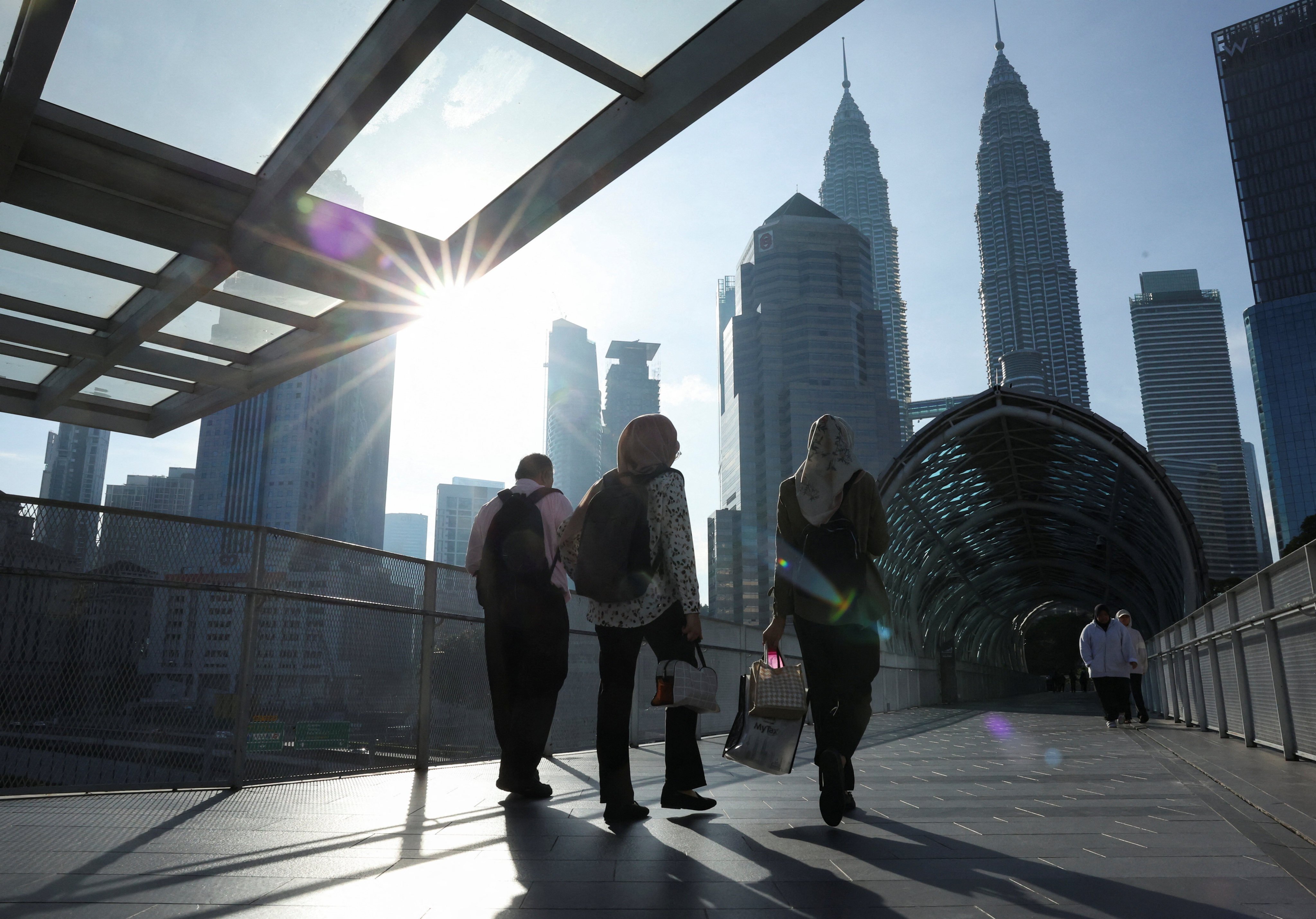 People walk to their workplace during the morning rush at Kuala Lumpur city centre. Photo: Reuters