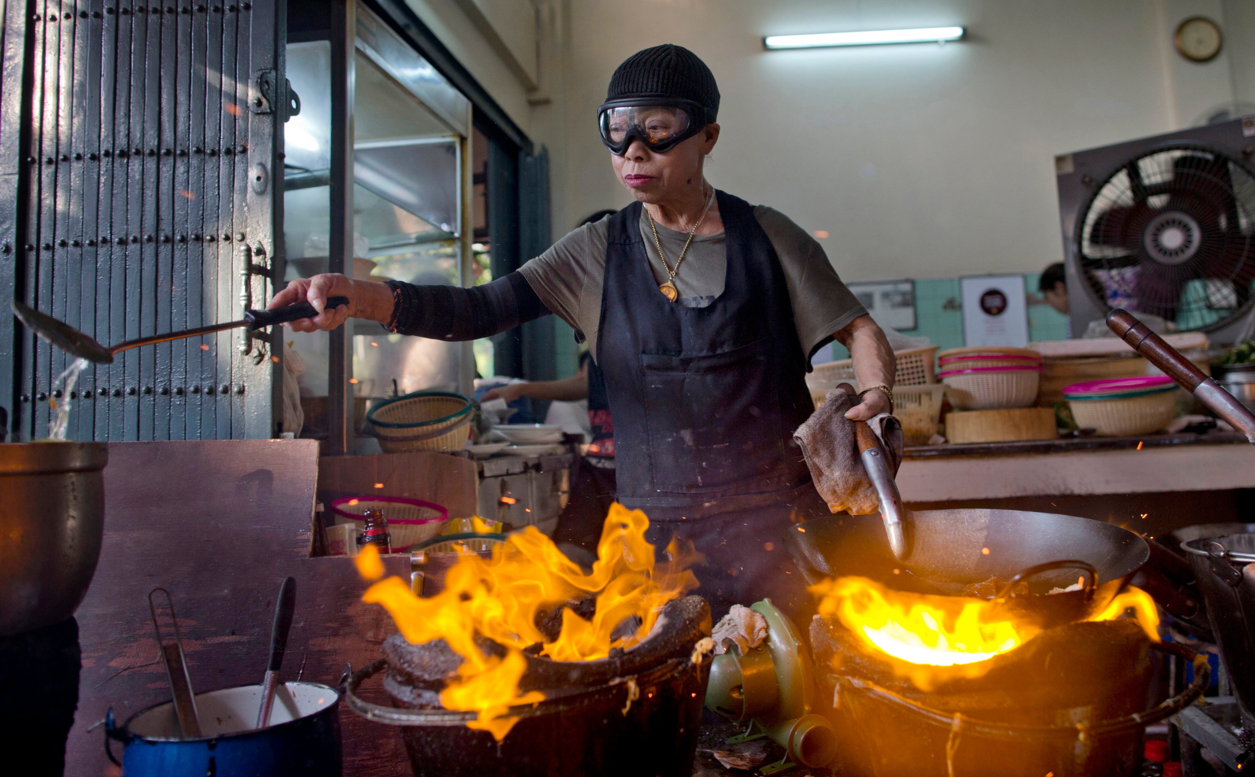 Thai street-food cook Jay Fai, awarded a Michelin star in 2018 and known for her crabmeat omelette, may be hanging up her signature ski googles as soon as next year. Photo: AP