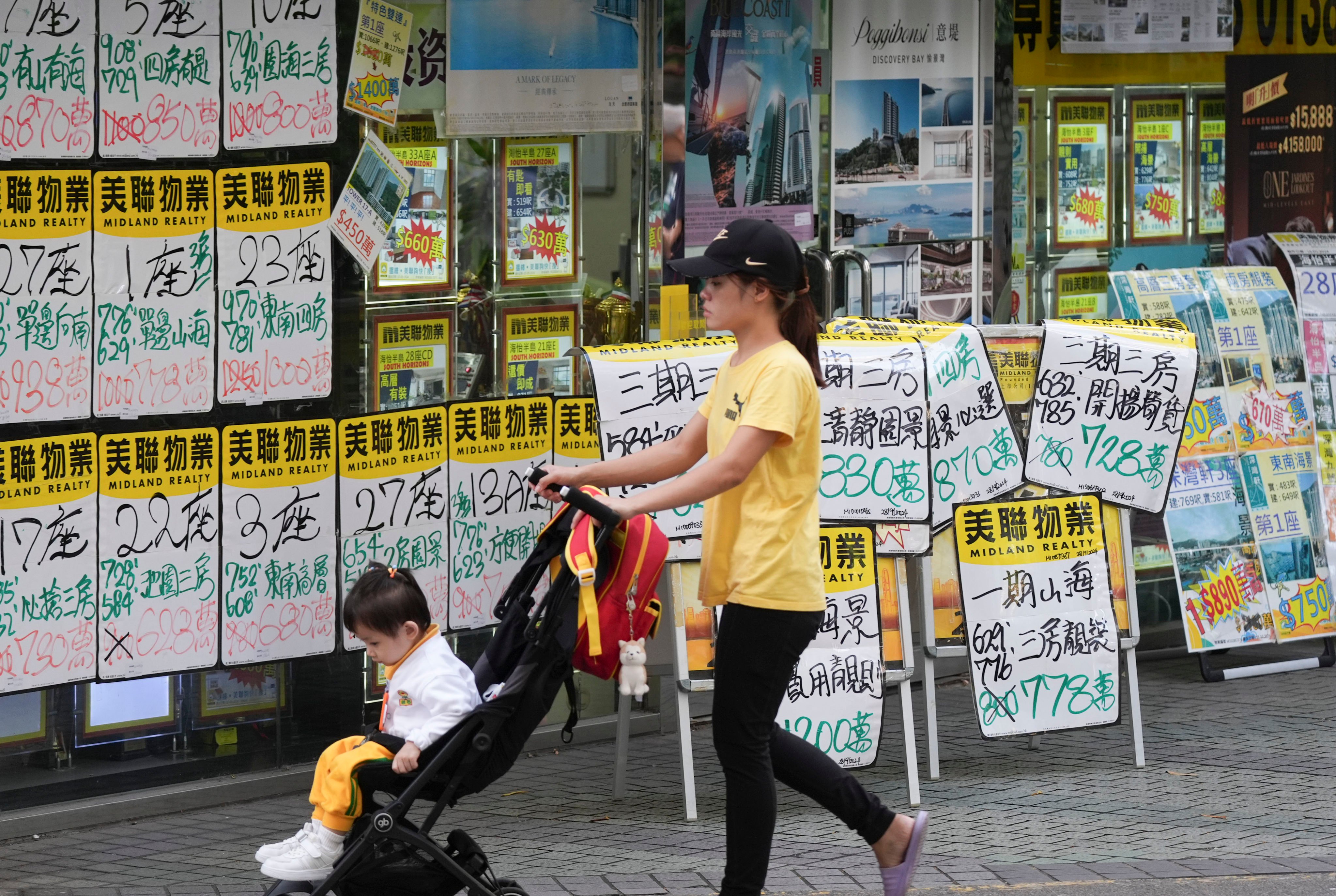 Homes listed for sale are displayed outside a property agency in Hong Kong. Photo: Eugene Lee