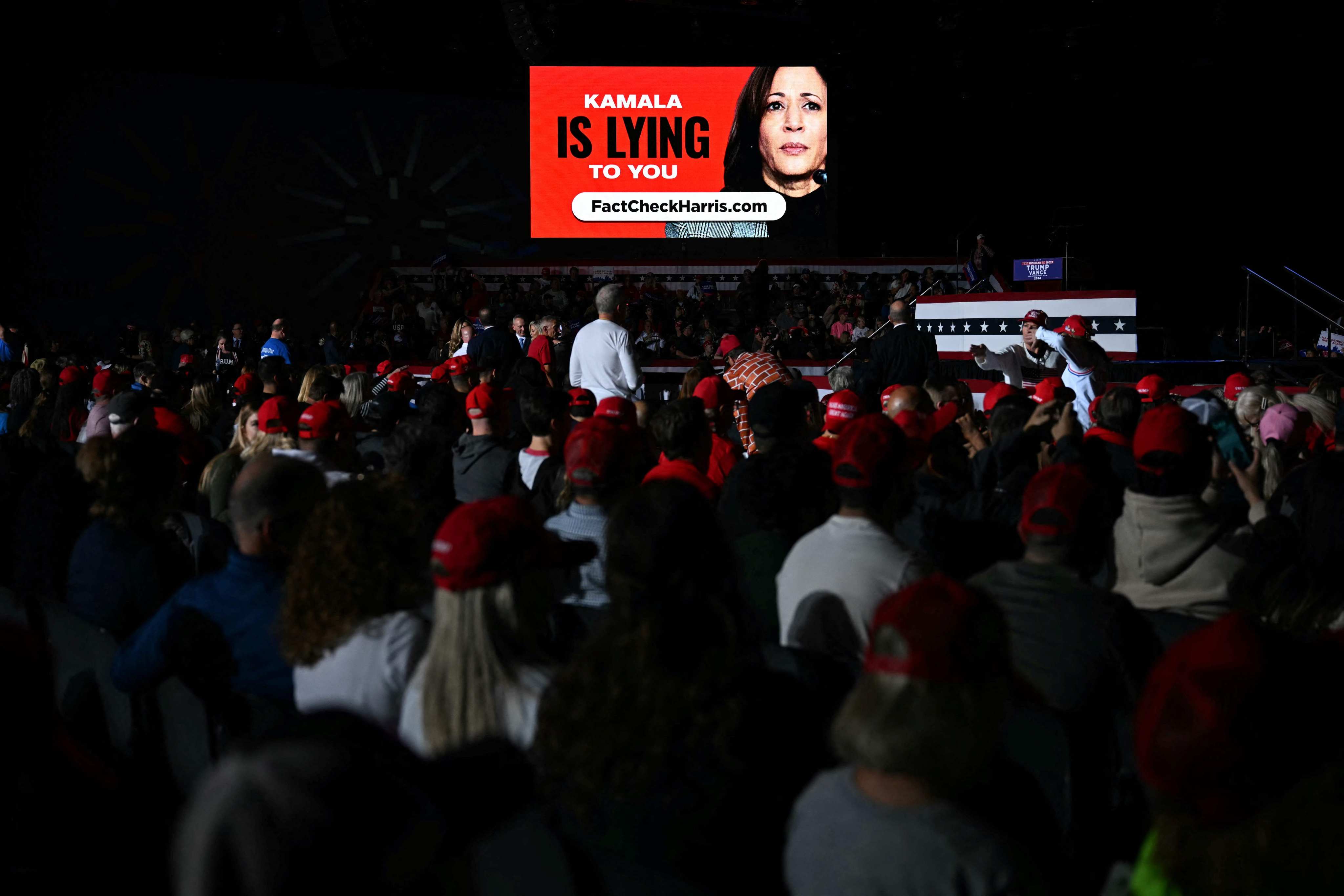 A screen at a Donald Trump campaign rally in Detroit, Michigan on October 18 shows pictures attacking election rival Kamala Harris. Photo: AFP