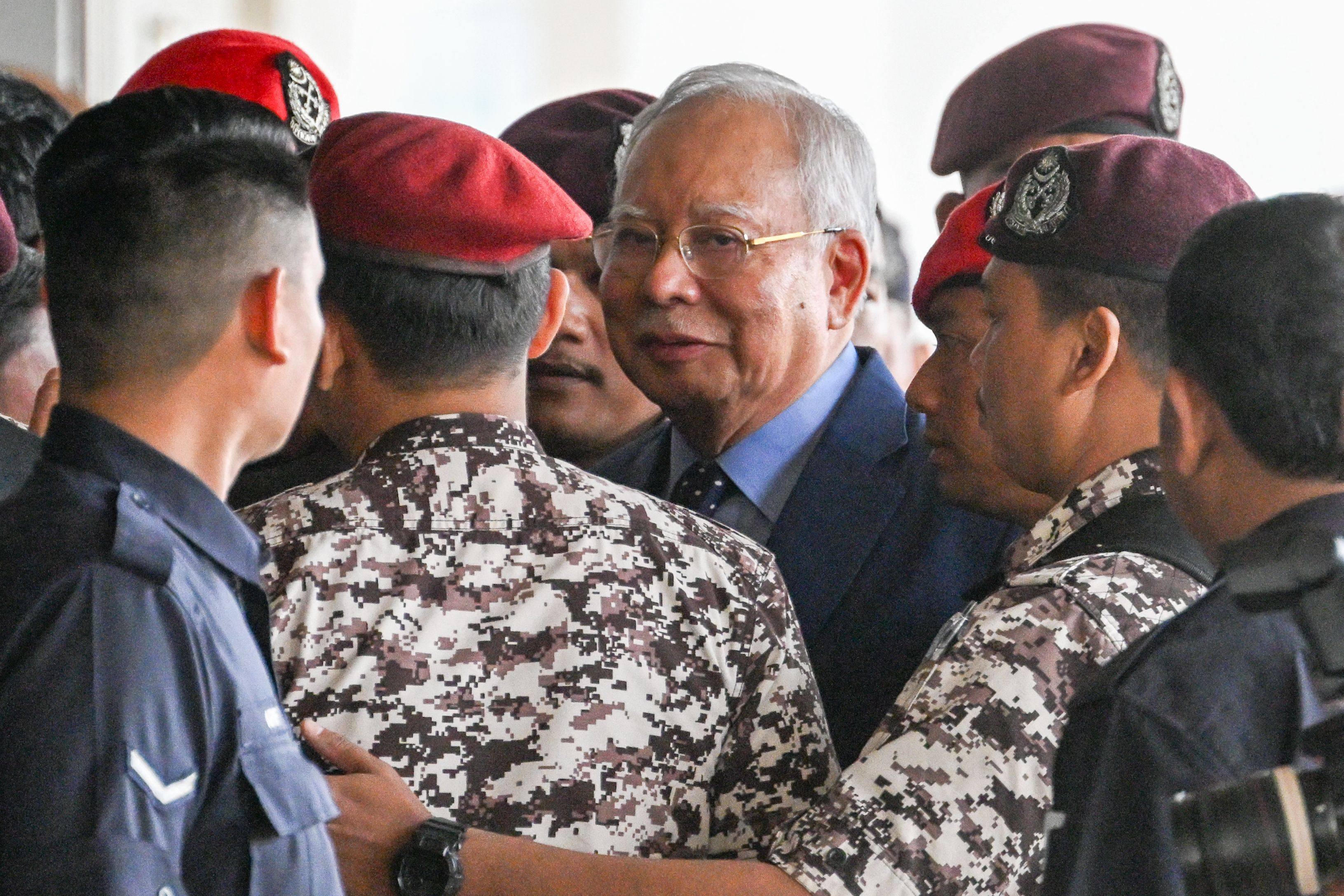 Former Malaysian prime minister Najib Razak (centre) arrives at the Kuala Lumpur Court Complex in Kuala Lumpur on Wednesday. Photo: AFP