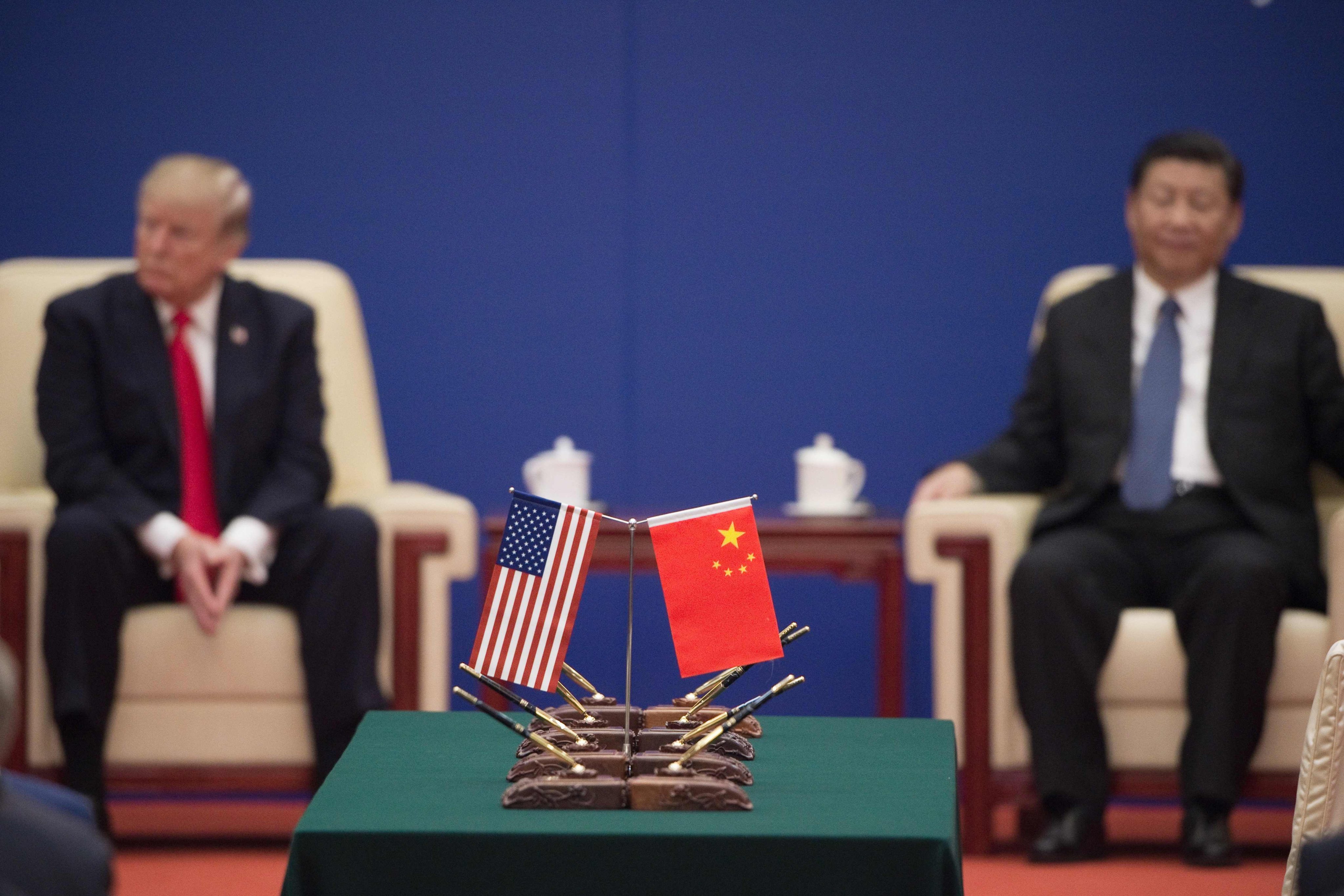 On November 9, 2017, US and Chinese presidents Donald Trump and Xi Jinping attend a business leaders’ event at the Great Hall of the People in Beijing. If re-elected, Trump will erect a Fortress America of trade with new tariffs, weakening middle industrial powers like Germany and Japan and solidifying the centrality of a G2 – China and the US. Photo: AFP 