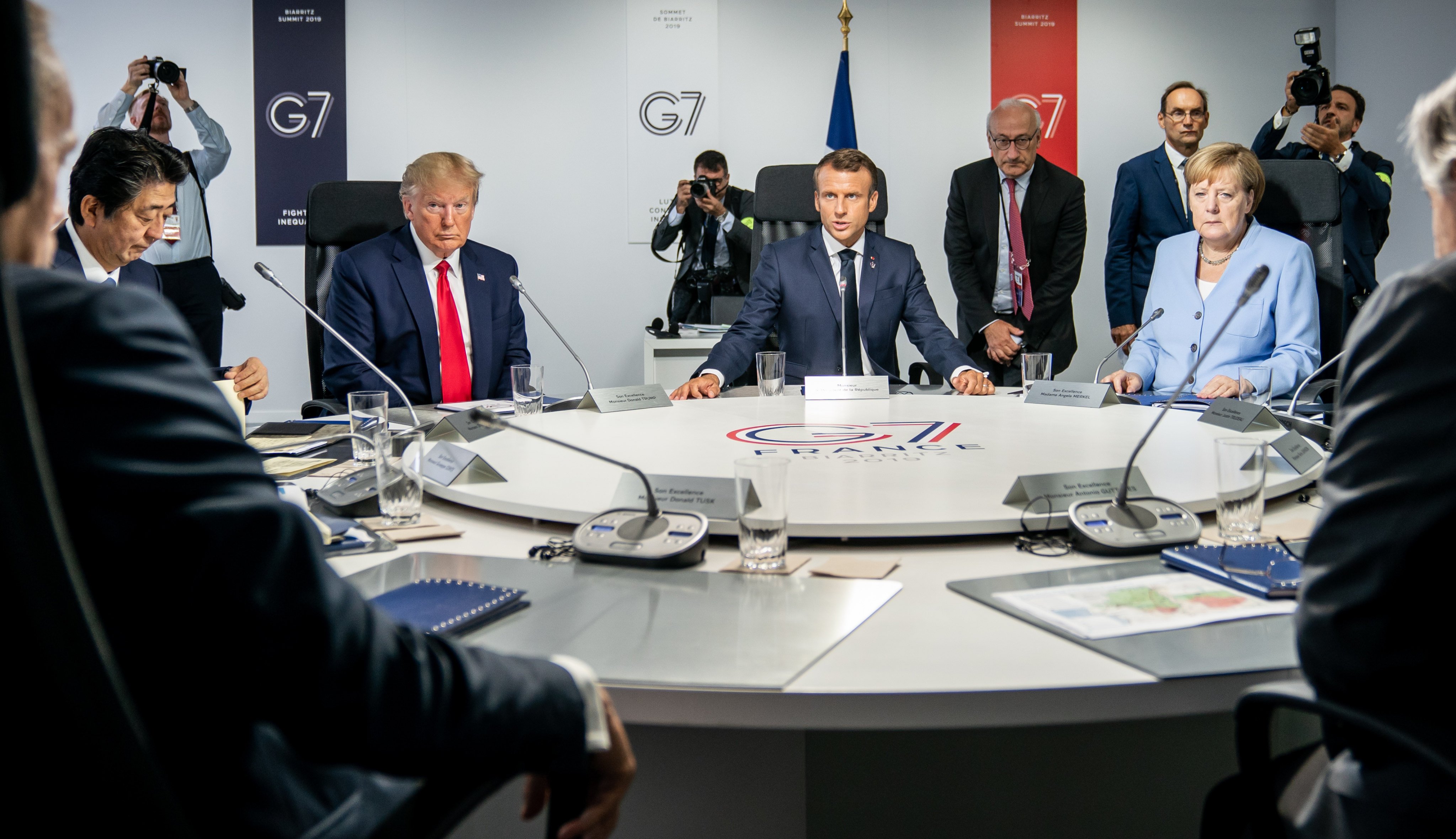 Then-Japanese prime minister Shinzo Abe (far left), then-US president Donald Trump (centre left), French president Emmanuel Macron (centre) and then-German chancellor Angela Merkel (far right) attend a meeting of the G7 summit in Biarritz, France, on August 26, 2019. Photo: dpa