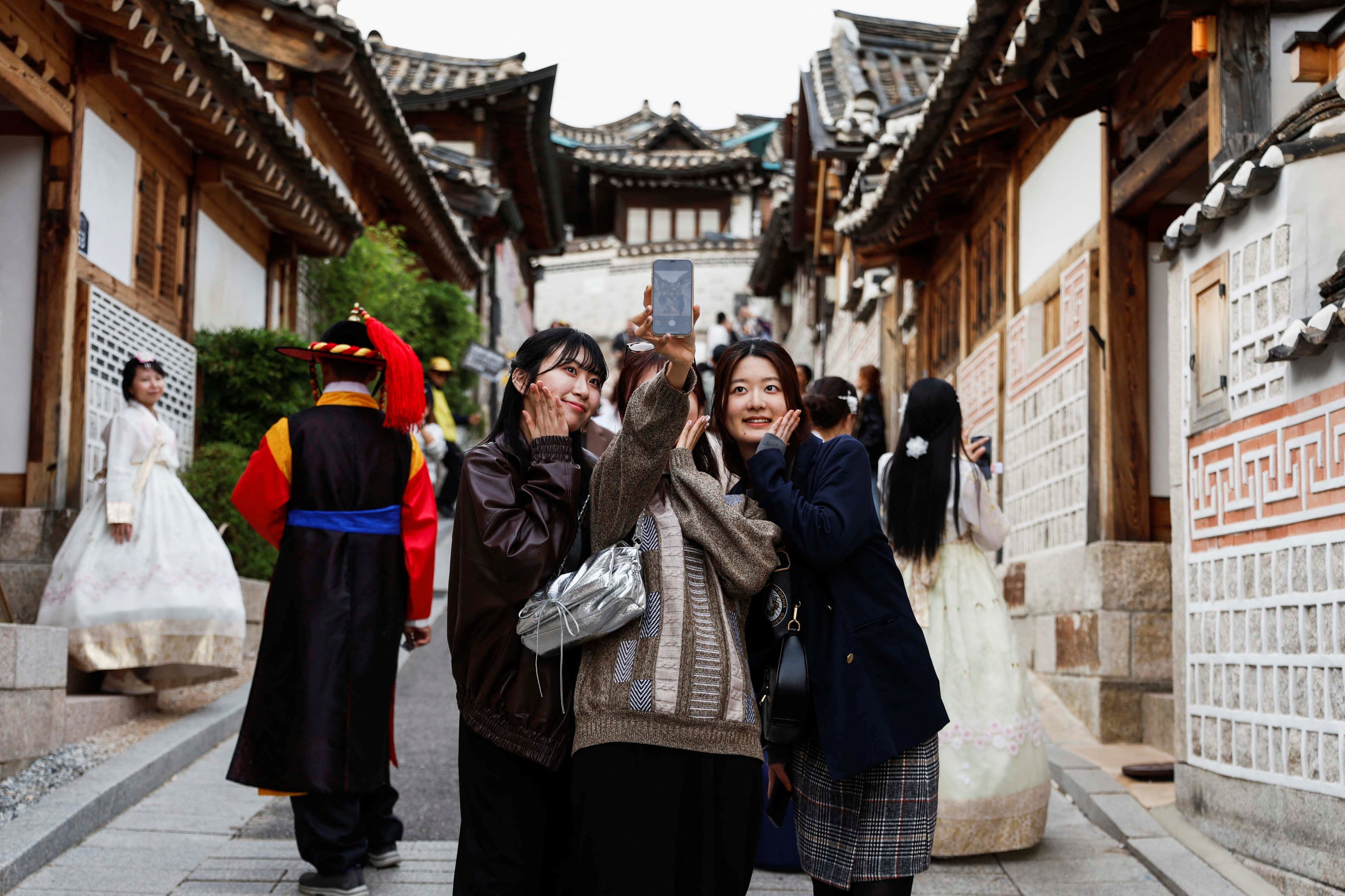 Tourists take selfies at Bukchon Hanok Village. Photo: Reuters