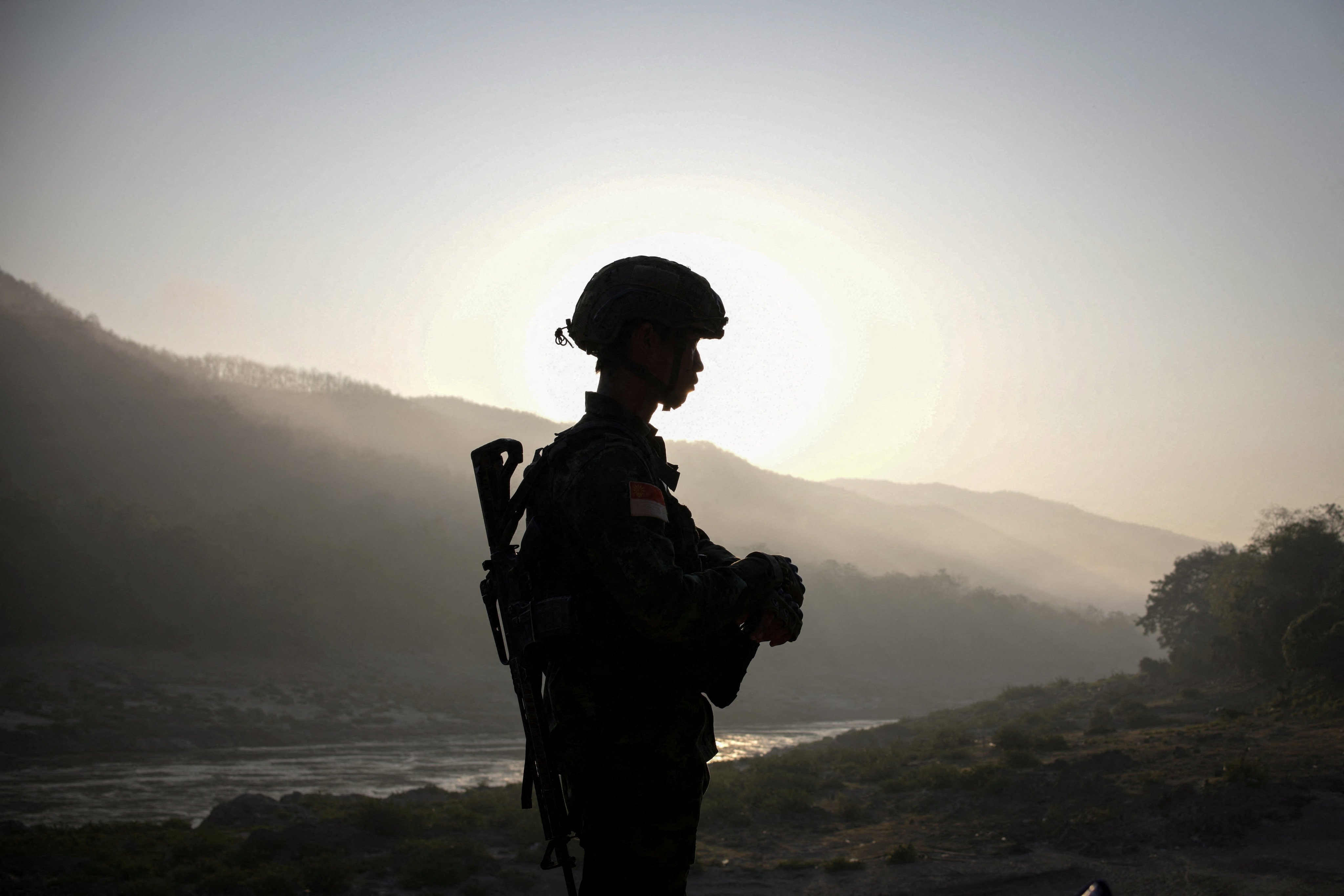 A rebel fighter stands guard in Karen state looking out over territory controlled by ethnic armed groups opposed to Myanmar’s military junta. Photo: Reuters