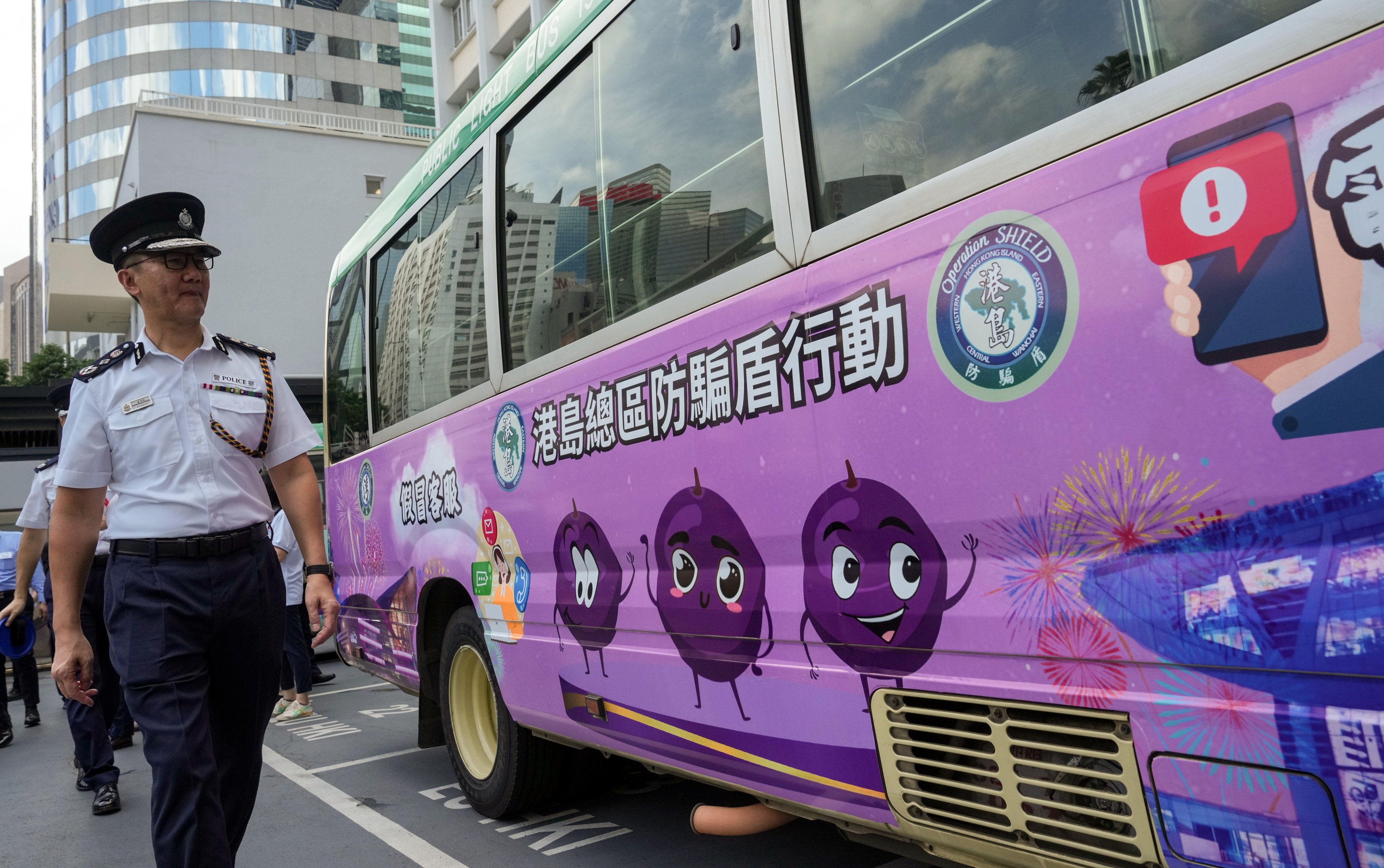 Commissioner of Police Raymond Siu attends the launch of five minibuses carrying adverts that promote scam prevention, on September 19. Photo: May Tse