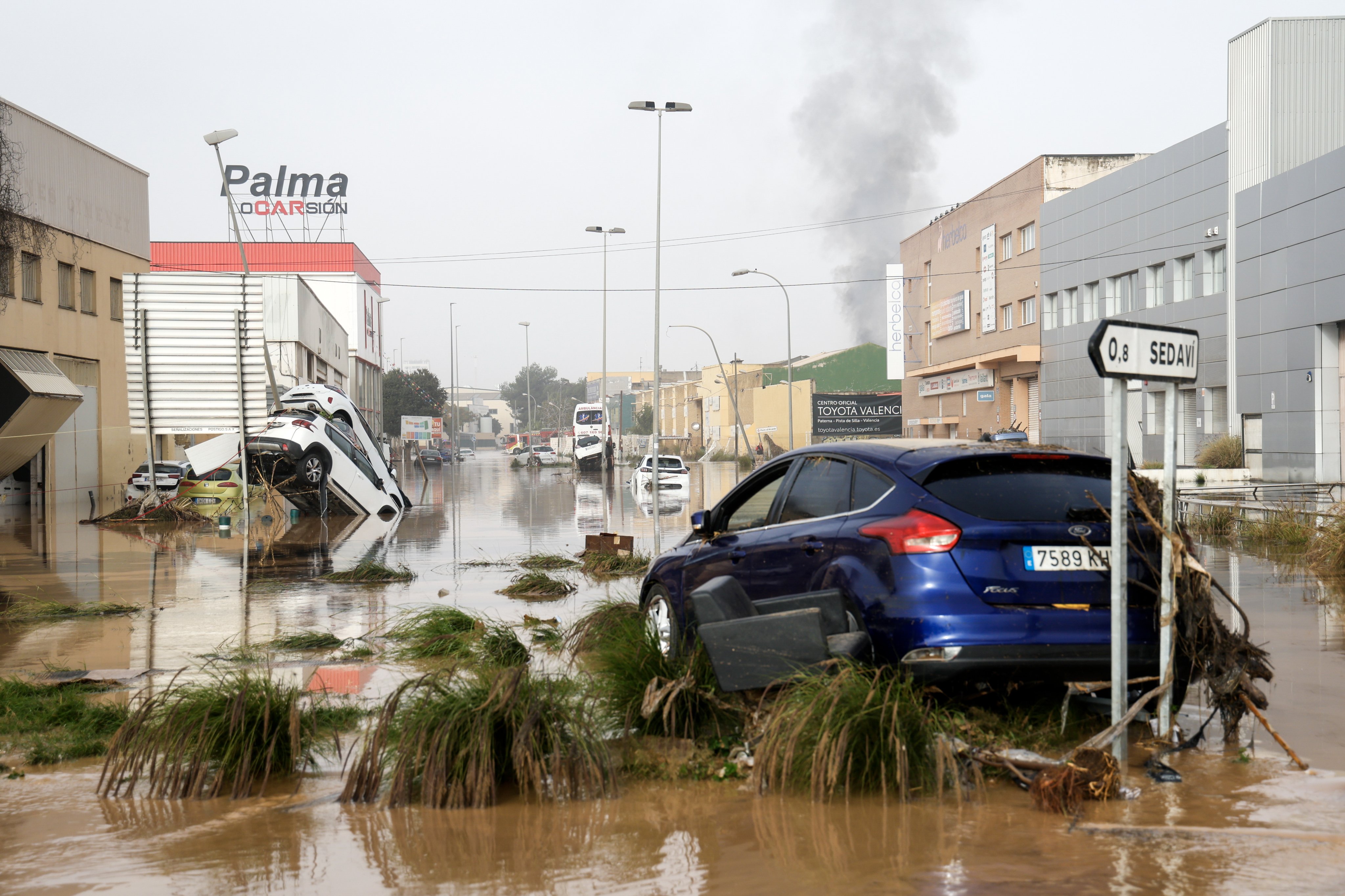 Damaged vehicles lie in flood waters at an industrial complex in Sedavi in the province of Valencia. Photo: EPA-EFE