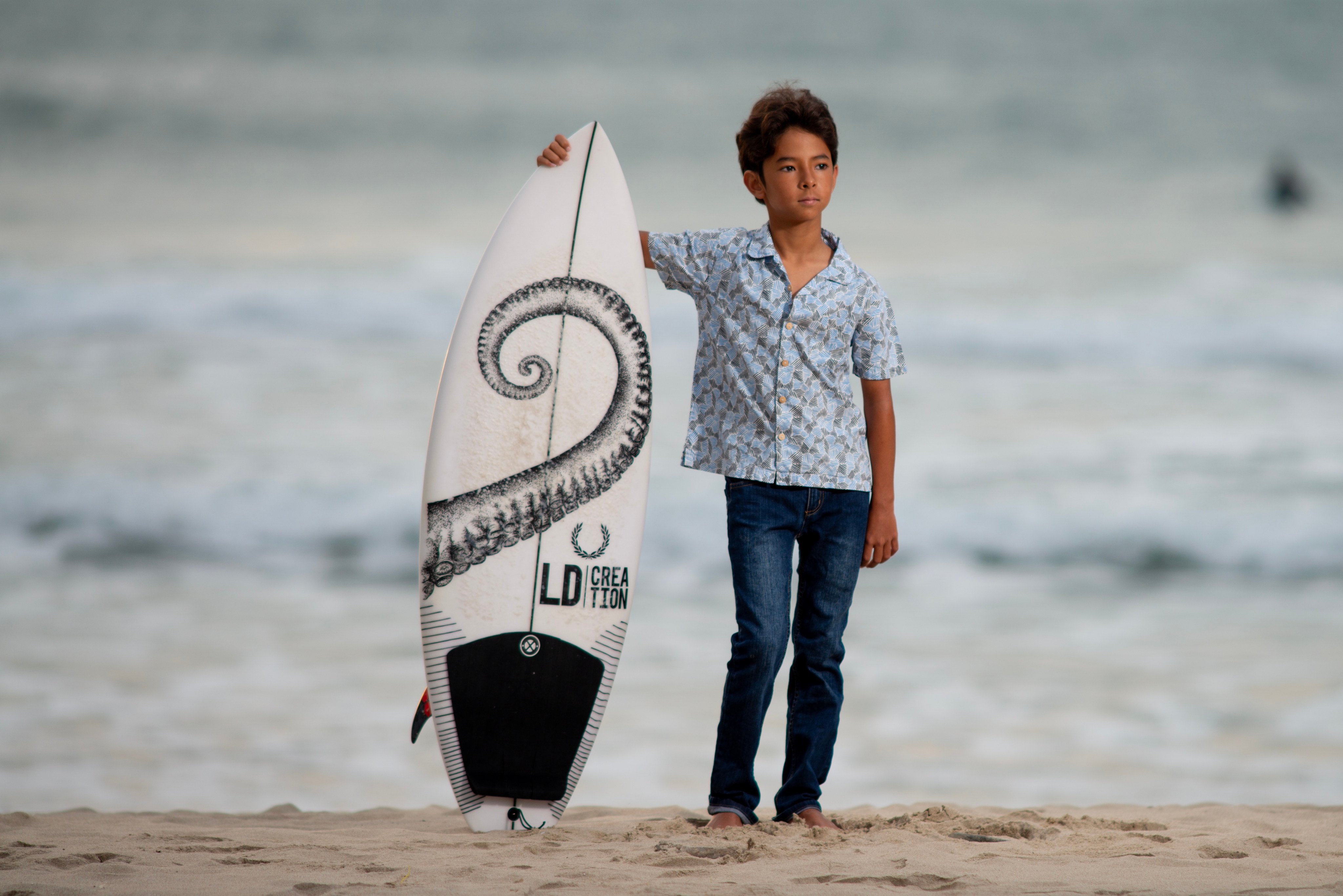 Mahohi Nguyen Tang stands with his surfboard in Big Wave Bay, Hong Kong. Photo: Antony Dickson