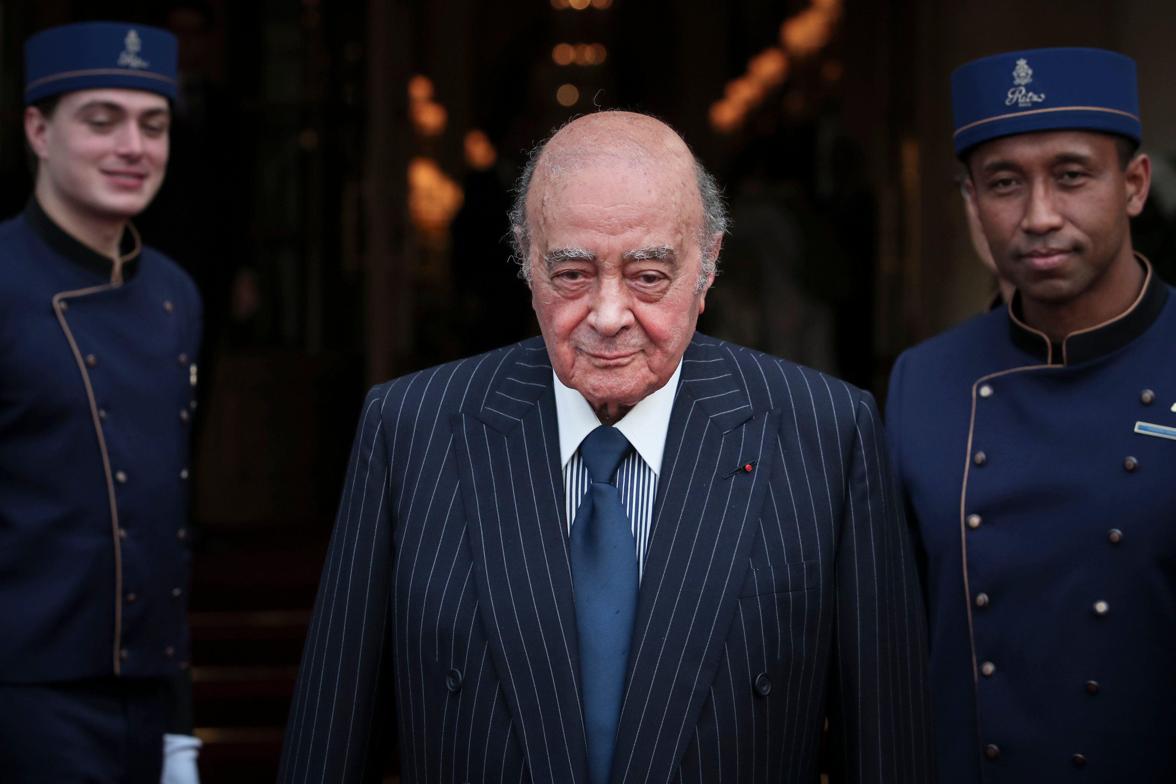 Egyptian businessman and Ritz hotel owner Mohammed Al Fayed poses with his hotel staff in Paris, in June 2016. Photo: AP