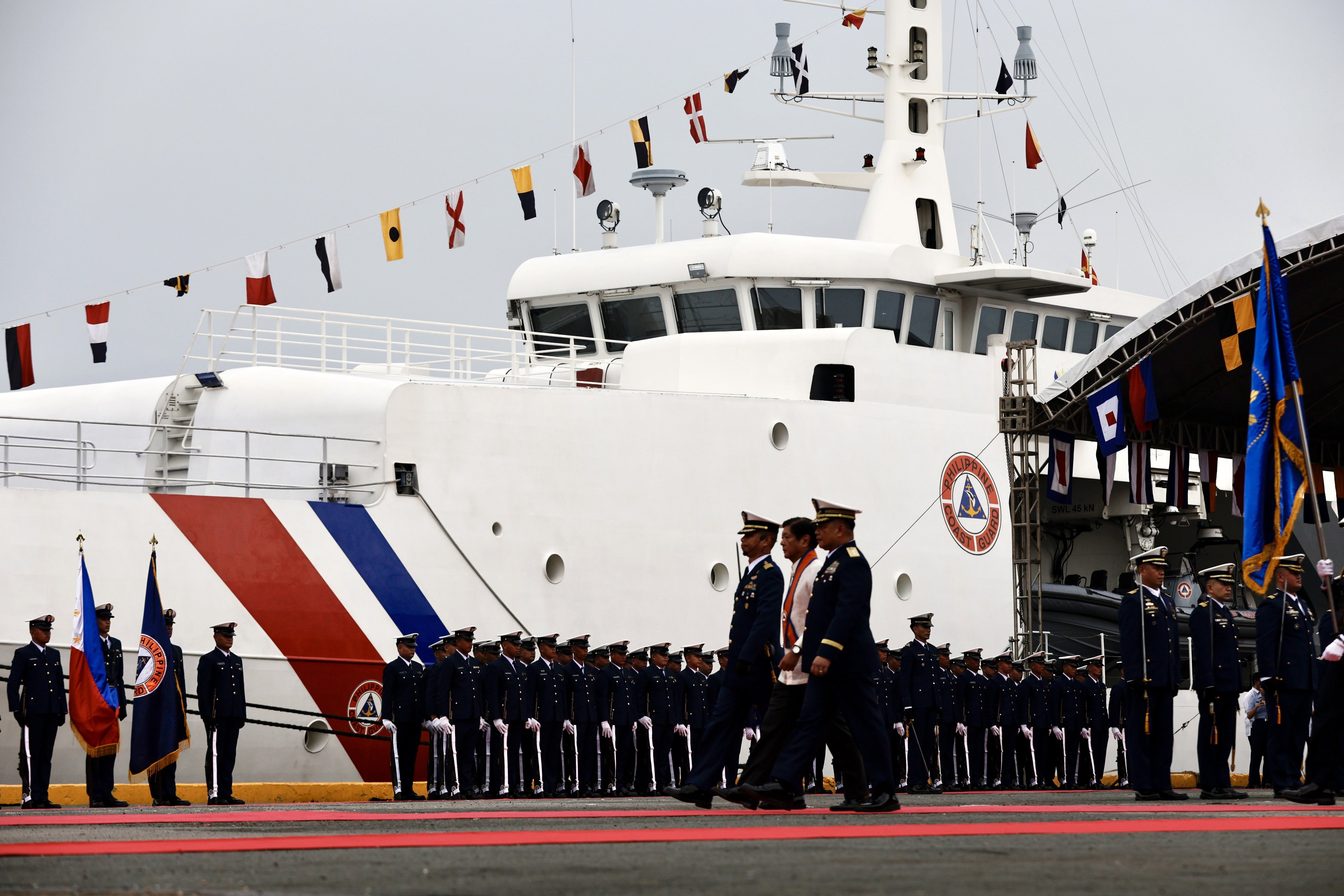 Philippine President Ferdinand Marcos Jnr reviews coastguard personnel next to the patrol ship BRP Gabriela Silang on October 22. Photo: EPA-EFE 