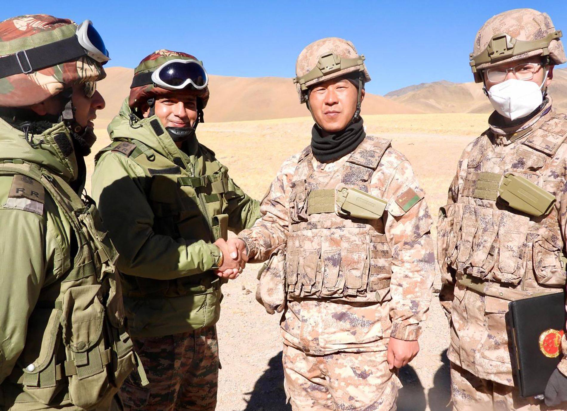 Indian and Chinese army members greet each other along the Line of Actual Control near Karakoram pass in Ladakh on October 31, on the occasion of Diwali. Photo: Indian Army/AFP