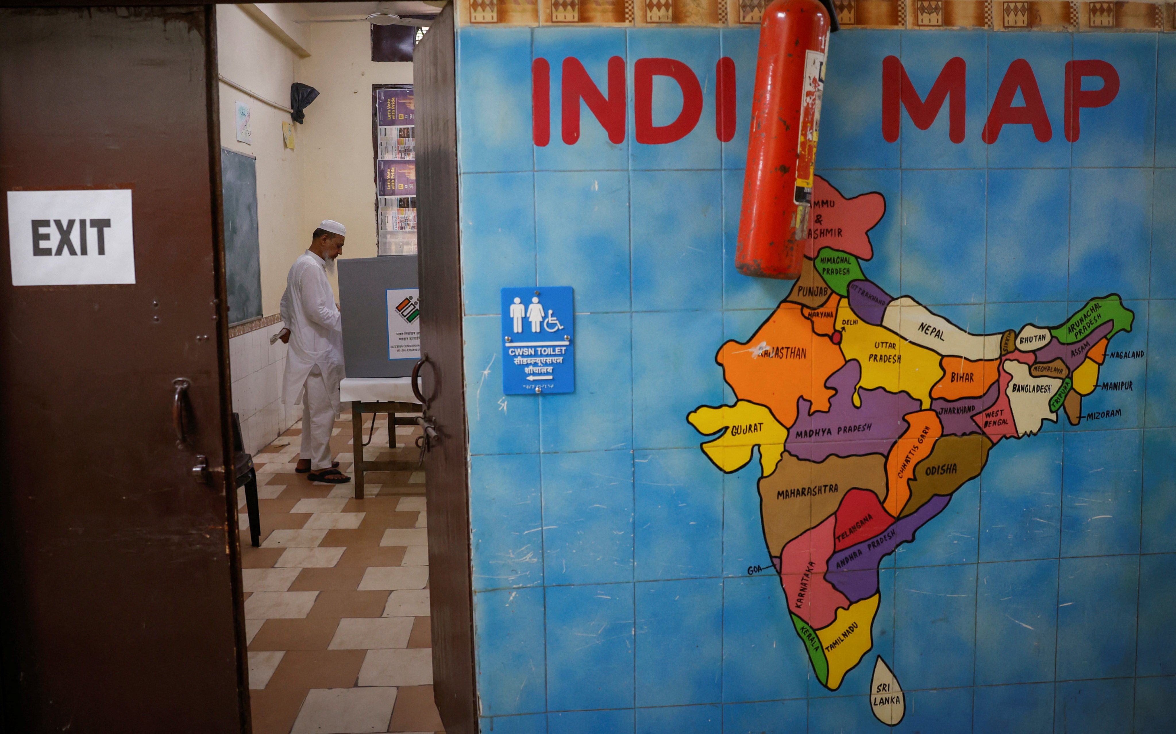 A man votes inside a booth at a polling station during the sixth phase of the general election, in the old quarters of Delhi, India, in May. Photo: Reuters