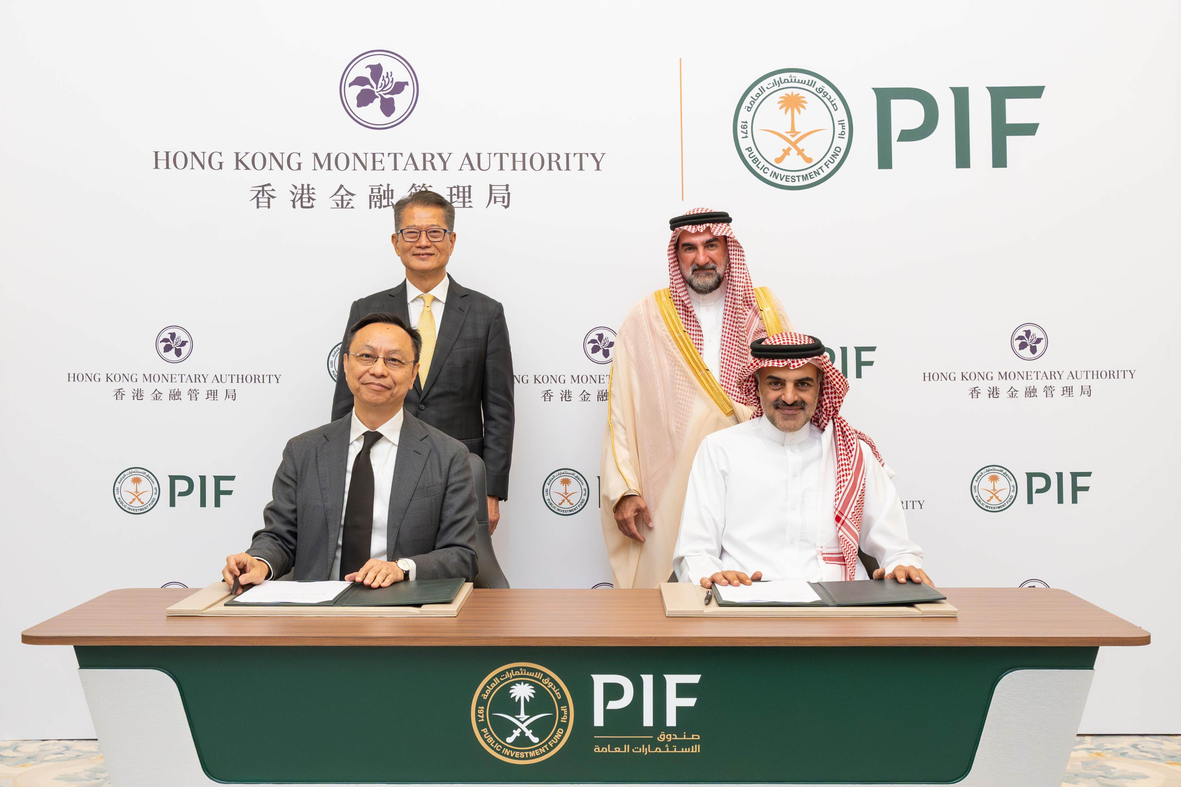 The deputy CEO of the Hong Kong Monetary Authority Darryl Chan (front left) and the head of the local real estate investments division of Saudi Arabia’s Public Investment Fund Aiman Almudaifer (front right), sign an agreement for a new investment fund in the presence of the Paul Chan, Hong Kong’s financial secretary (back left), and the governor of the PIF, H.E. Yasir Alrumayyan (back right). Photo: Handout