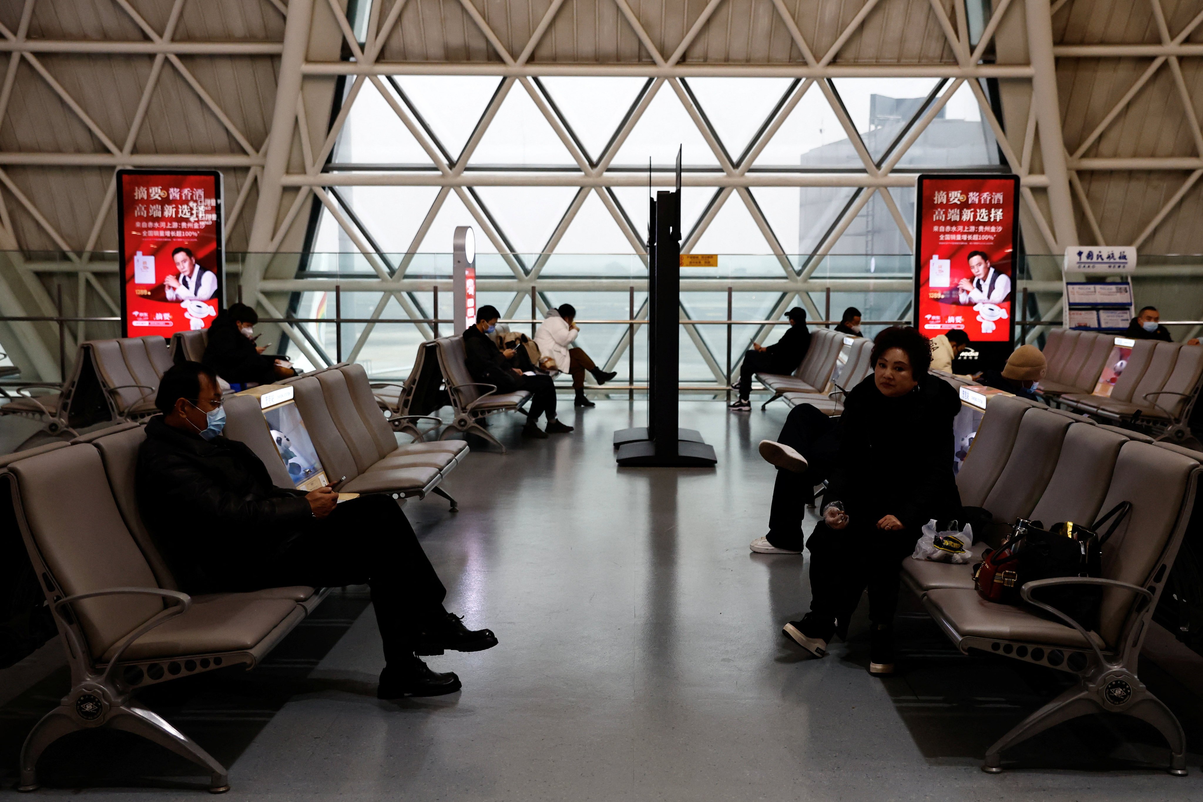 Travellers waited to board a plane at an airport in Chengdu, China. Photo: Reuters 