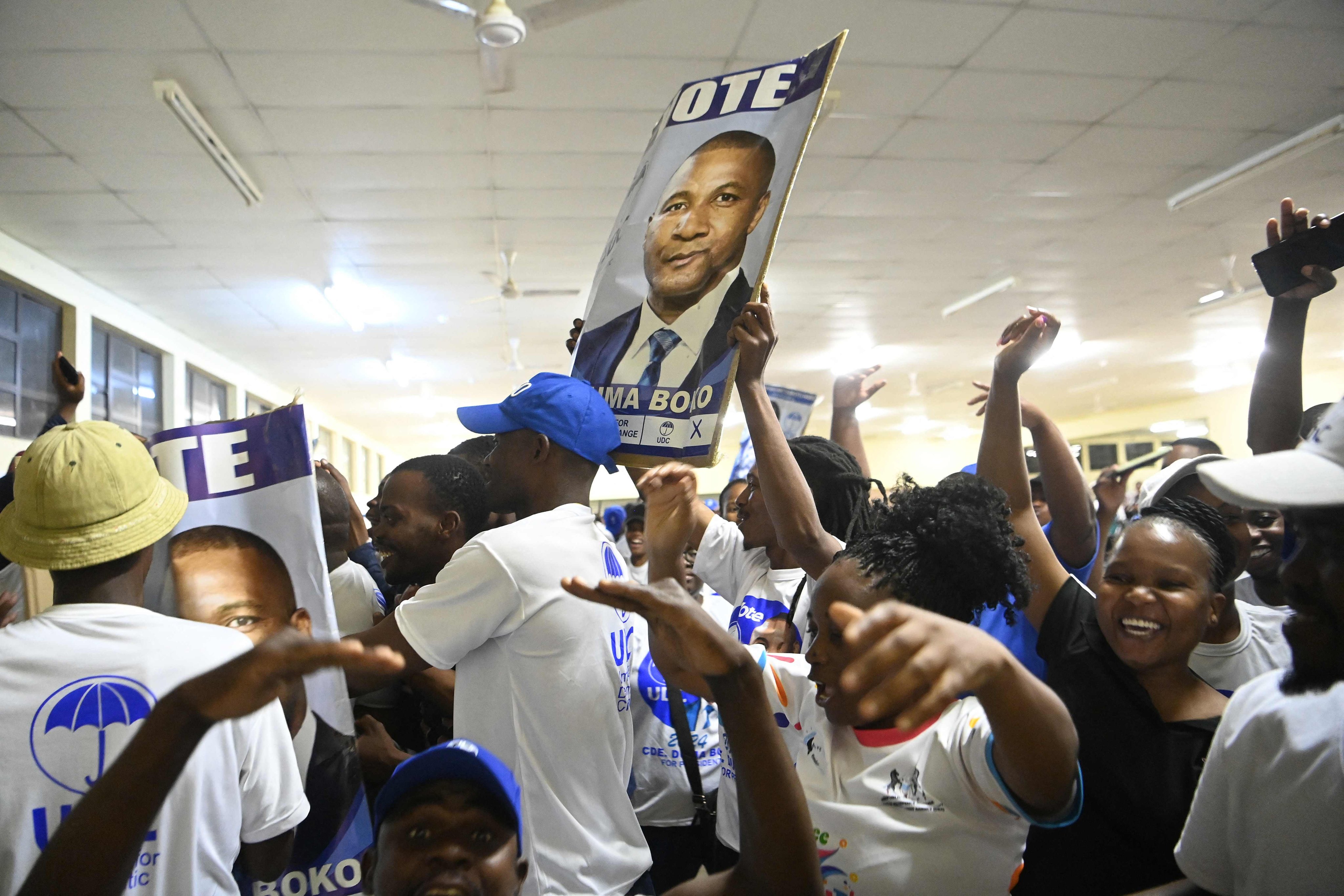 Supporters of the main opposition Umbrella for Democratic Change cheer at a counting centre in Gaborone, Botswana. Photo: AFP