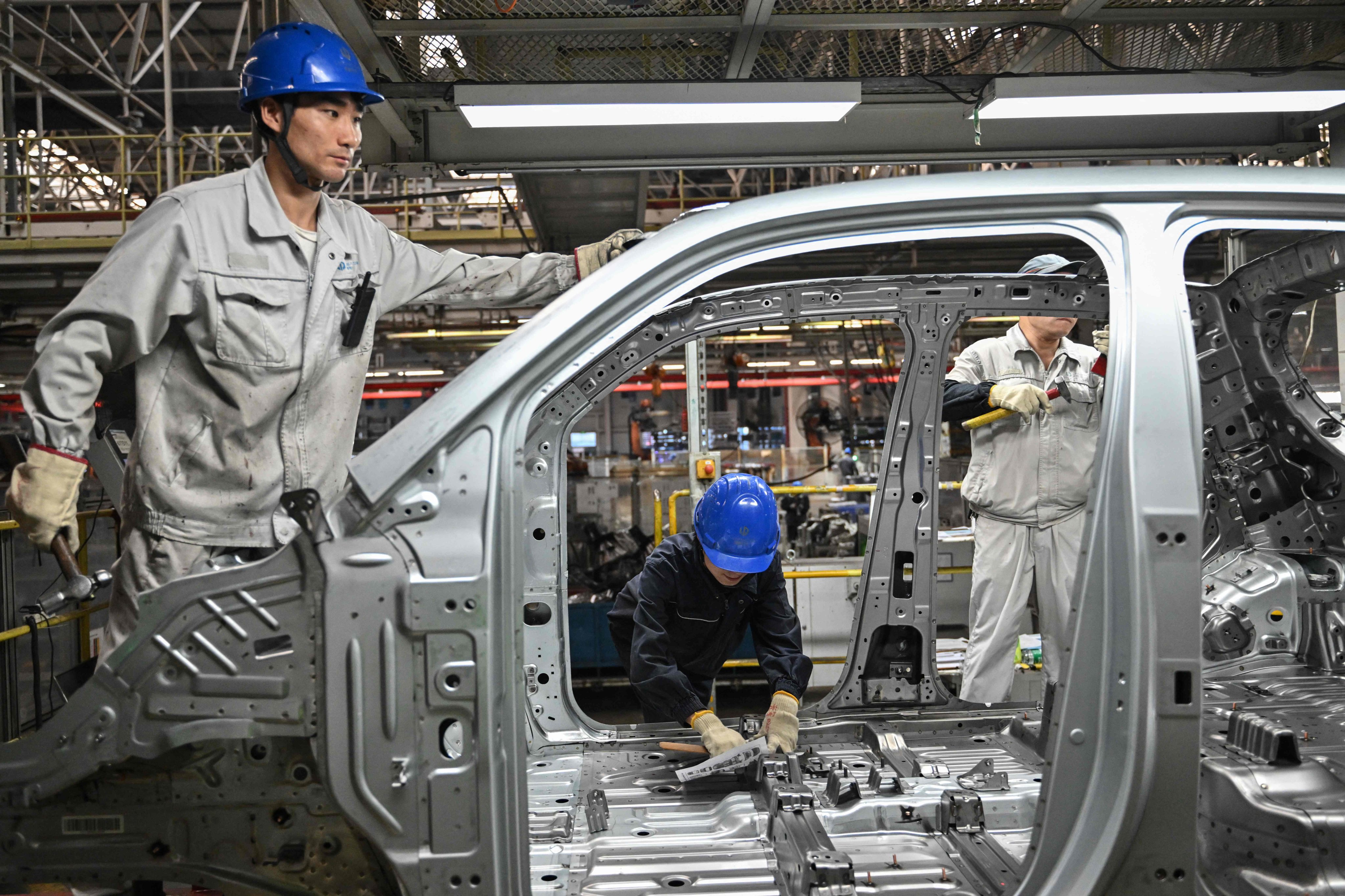 Employees work on an electric vehicle production line at a Leapmotor factory in Jinhua, in China’s eastern Zhejiang province, on September 18, 2024. Photo: AFP