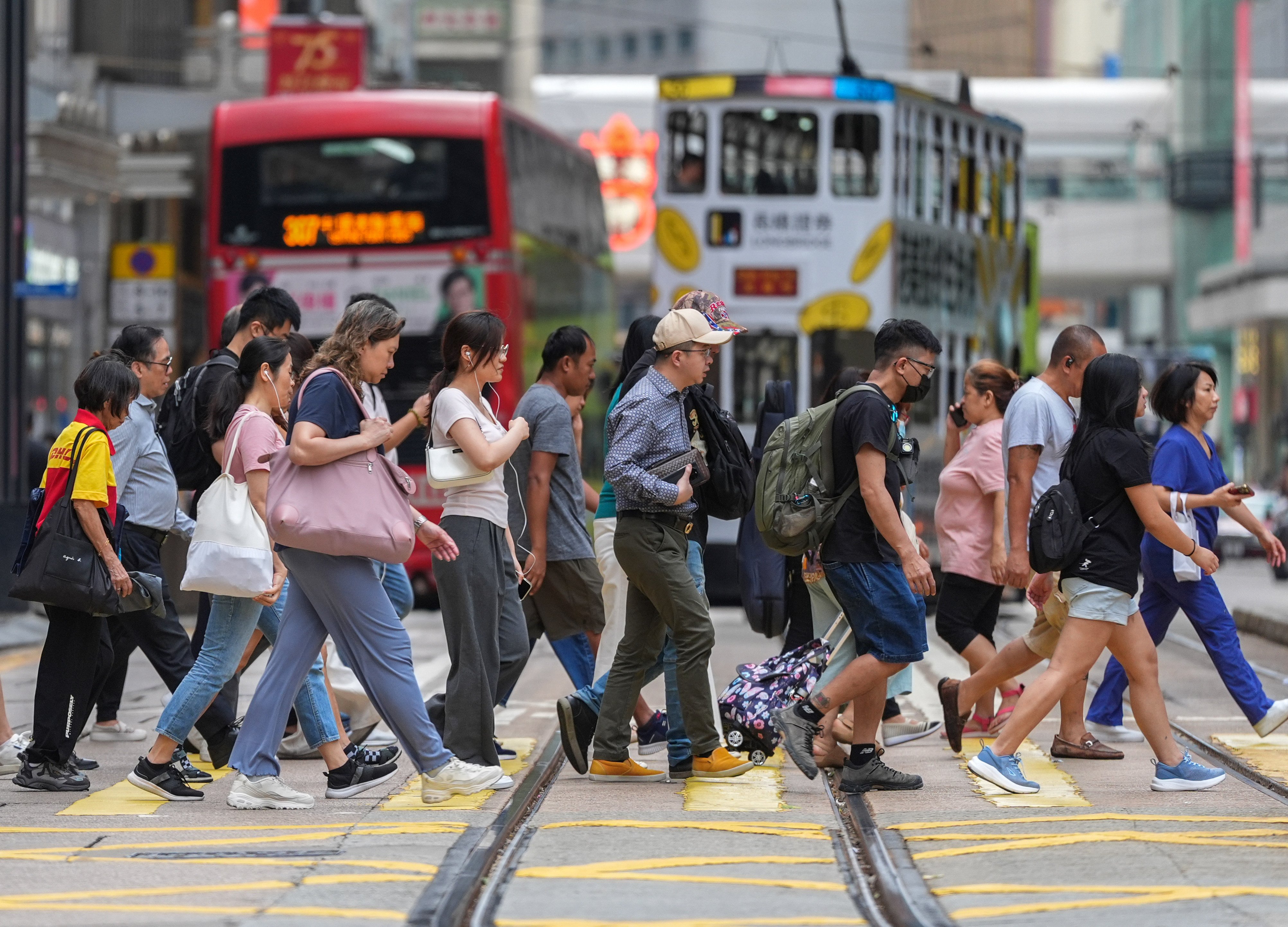 People cross the street in Central. Photo: Eugene Lee