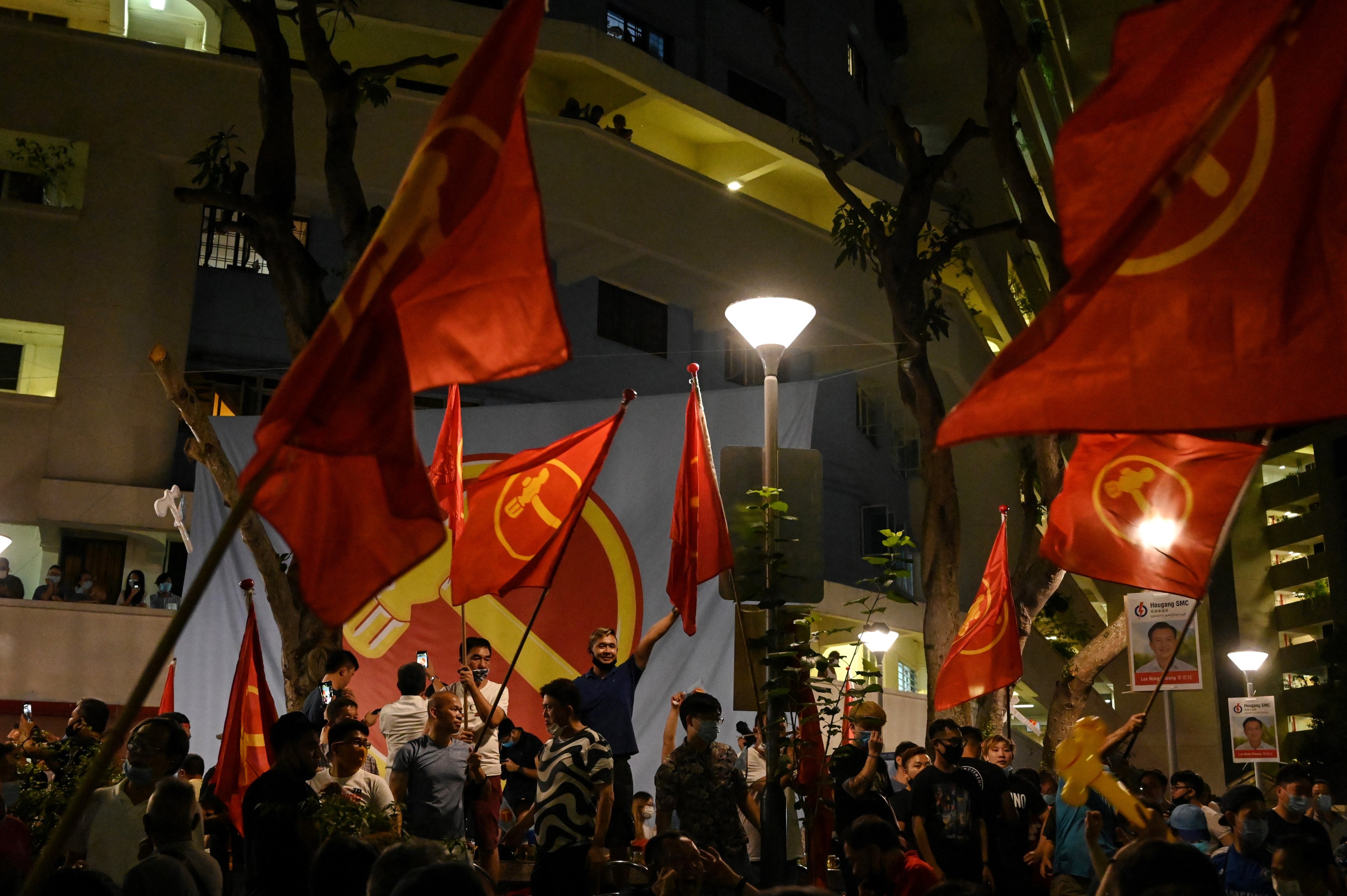 Supporters of the opposition Workers’ Party wave party flags as they gather in Hougang after the general election in 2020. Photo: AFP