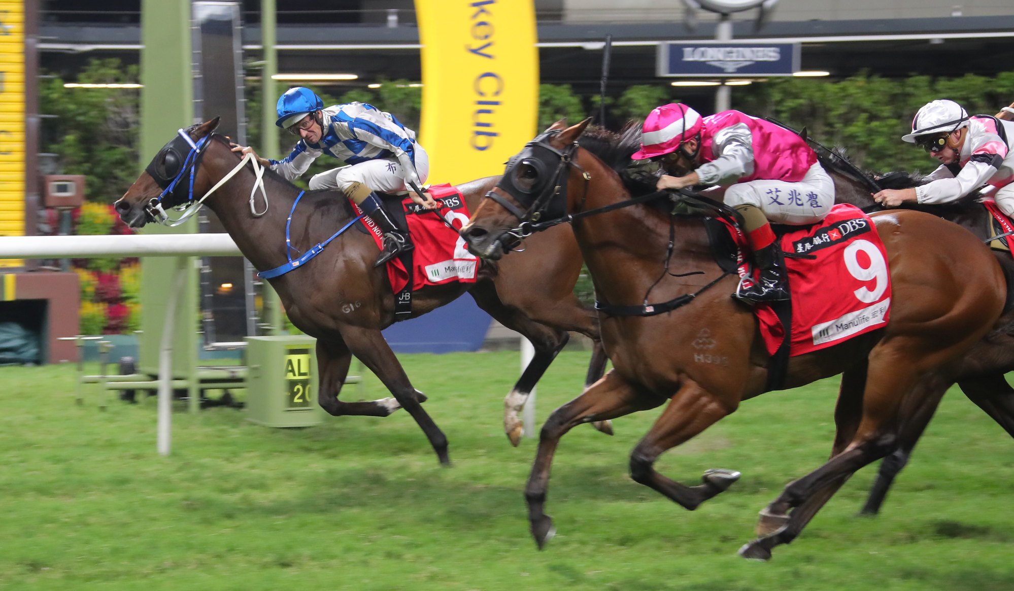 Hugh Bowman salutes aboard Sugar Sugar (inside) at Happy Valley on Wednesday.