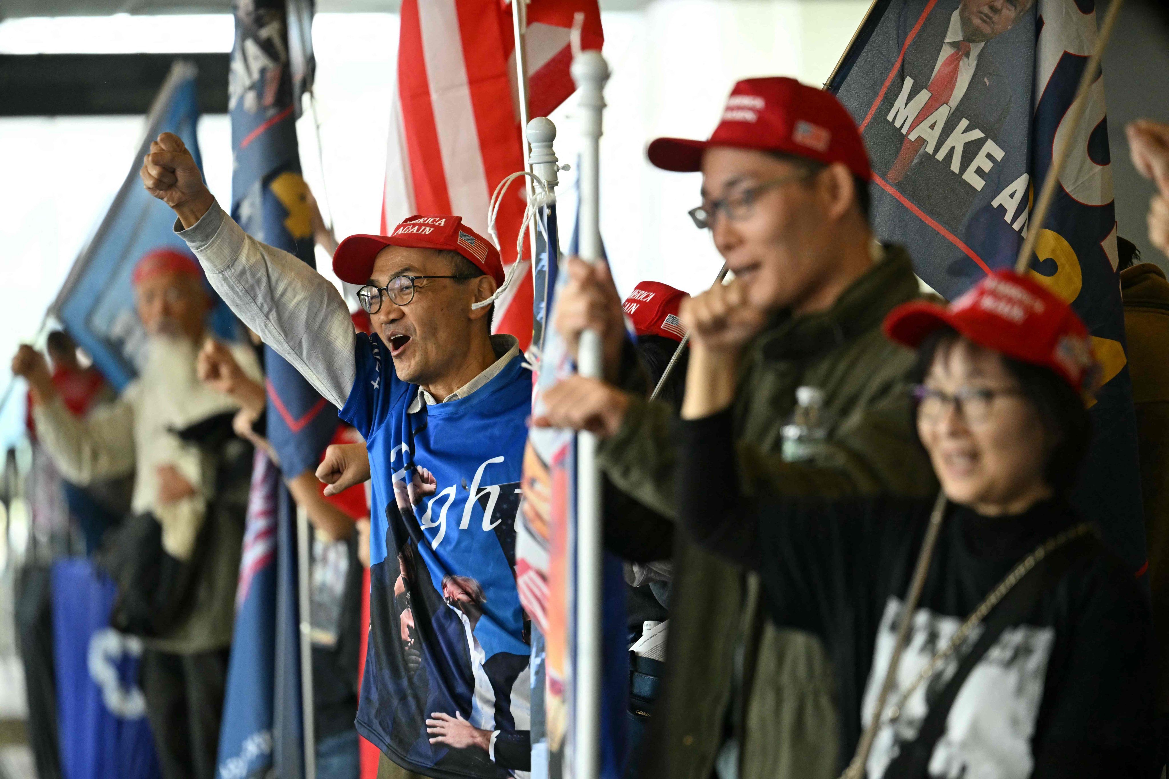 Asian-American supporters of Republican presidential candidate Donald Trump cheer during a campaign rally in Detroit on October 18. Photo: AFP