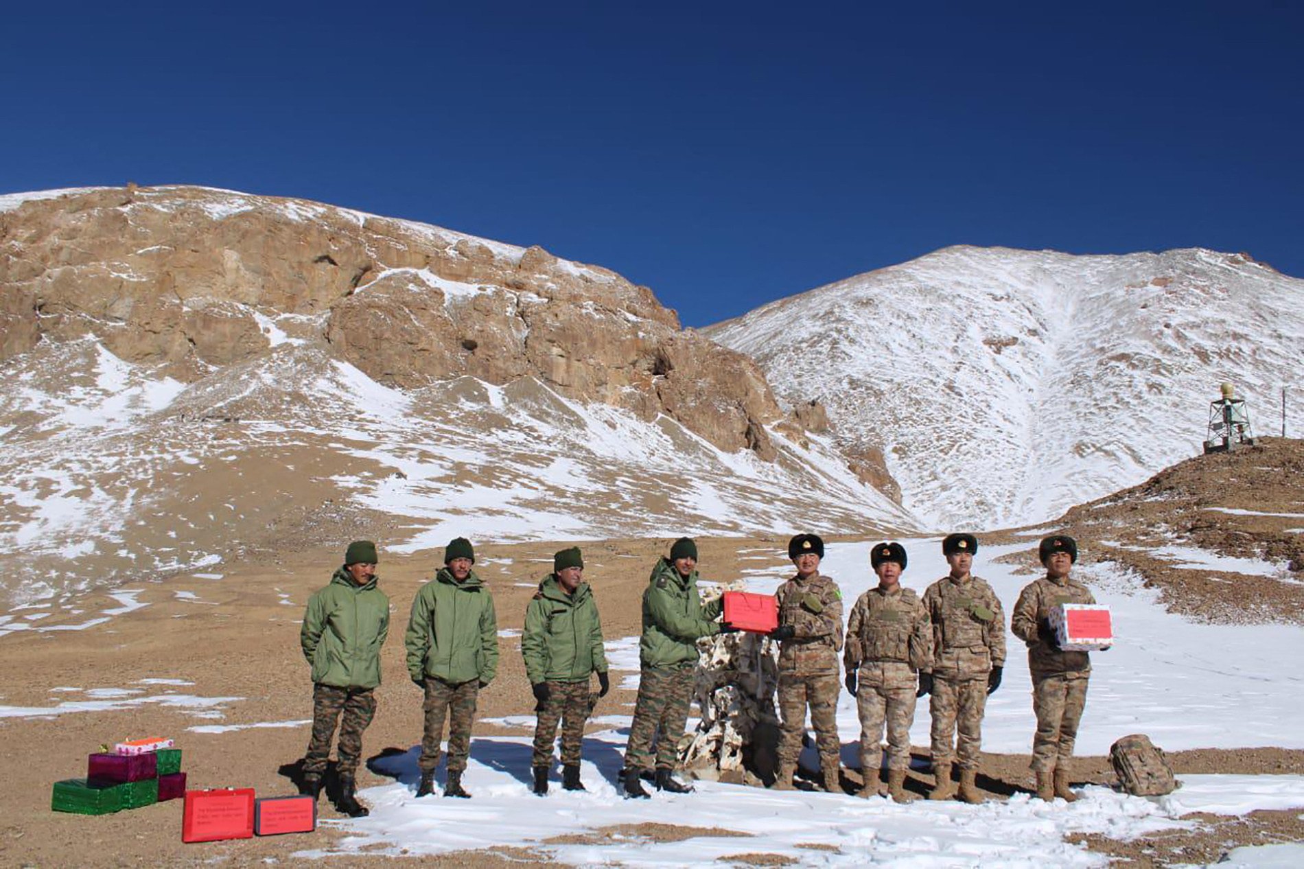 Indian and Chinese soldiers greet each other along the Line of Actual Control near Karakoram Pass on Thursday. Photo: AFP