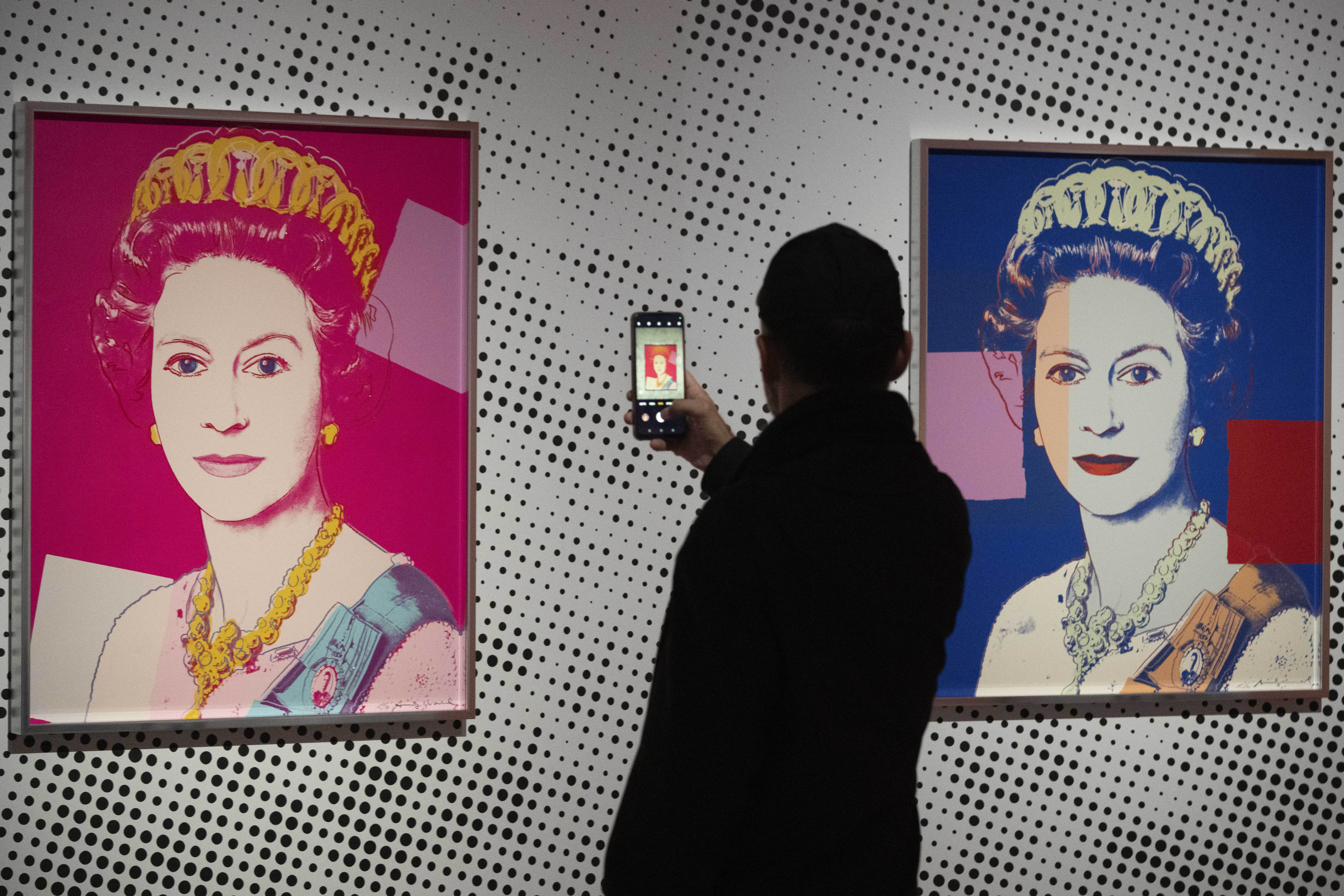 A man takes an image of a screen print on show in Apeldoorn, Netherlands, depicting Queen Elizabeth II, one in a series of 16 by Andy Warhol and similar to a work stolen from a gallery in Oisterwijk, Netherlands, early on November 1, 2024. Photo: AP