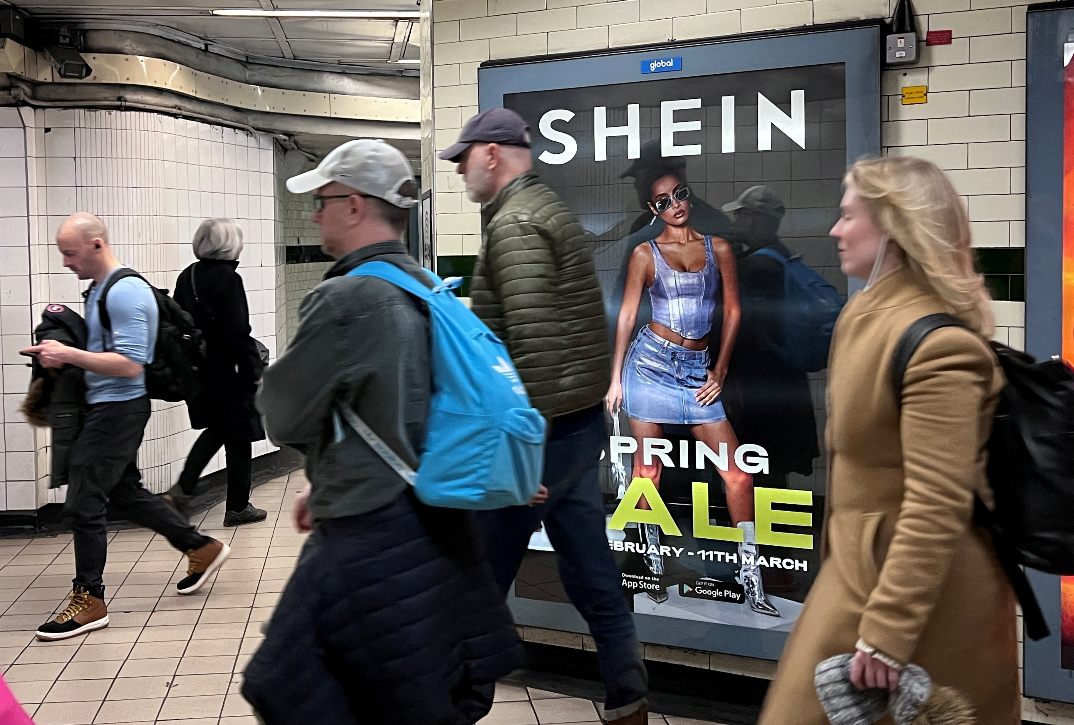 People walk past a Shein advertisement in London, where the the fast-fashion giant plans to go public. Photo: Reuters