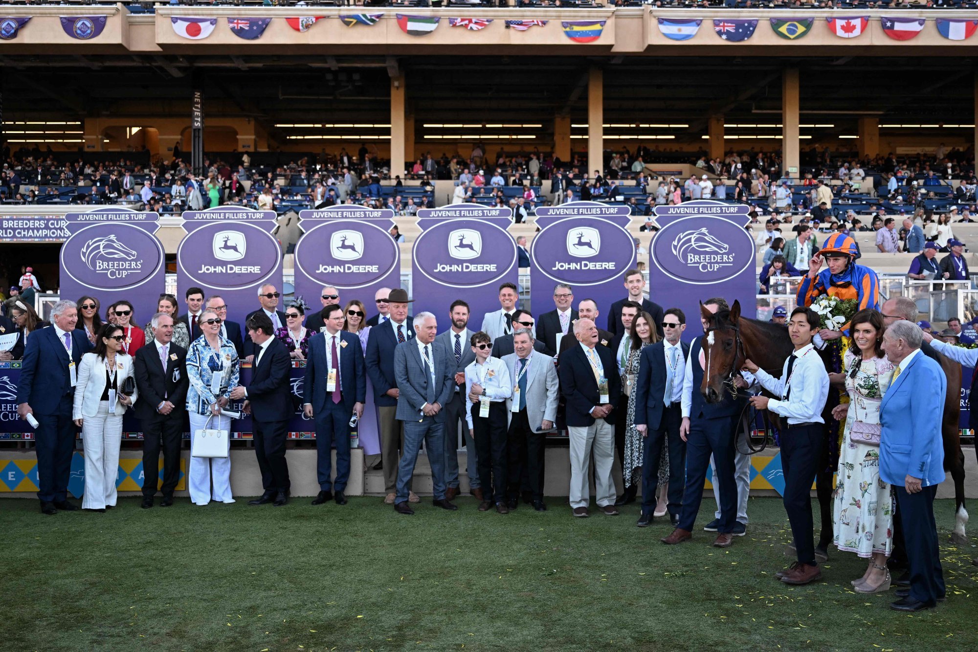 Lake Victoria, ridden by Ryan Moore, poses for a group photograph after winning the Breeders’ Cup Juvenile Fillies Turf. Photo: AFP