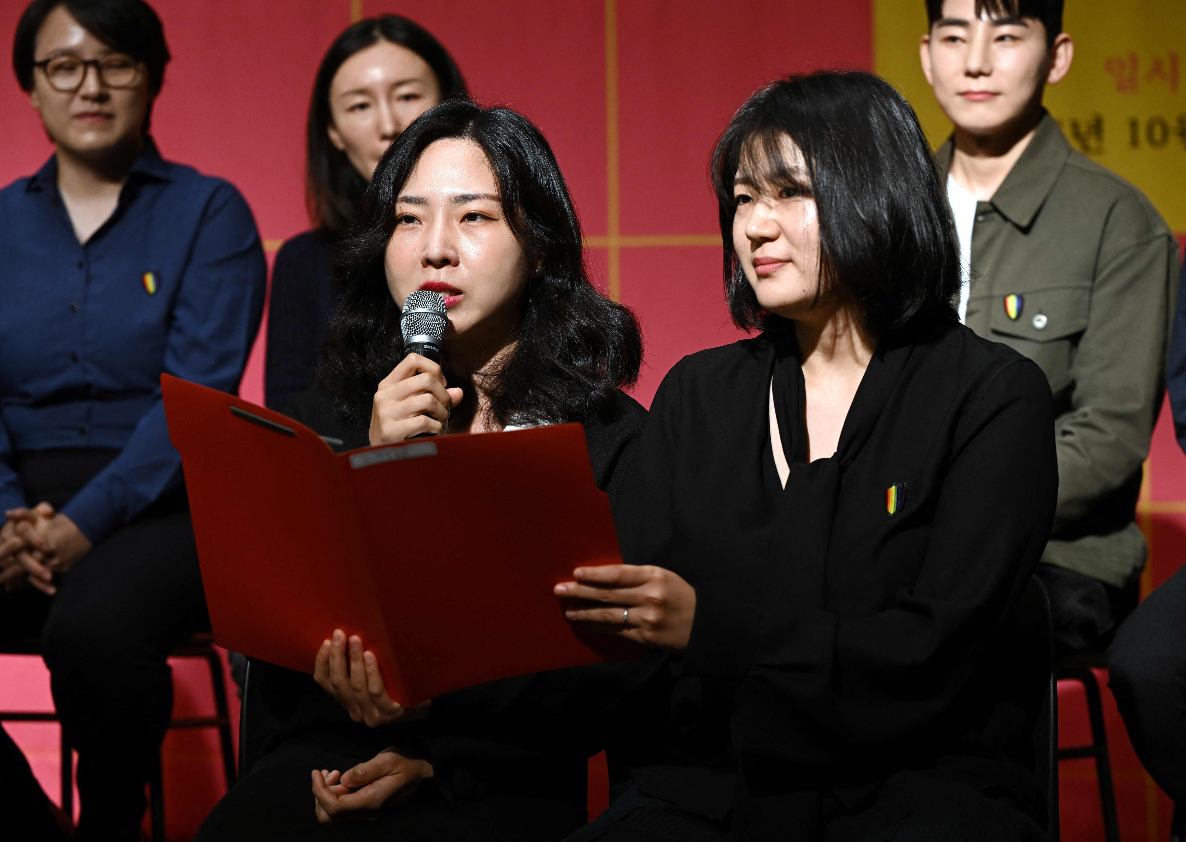 Kim Sae-yeon (left) and her partner Kim Kyu-jin speak during a press conference at which they and 10 other Korean same-sex couples announced their intention to file a lawsuit against district offices’ rejection of their marriage registrations. Photo: AFP