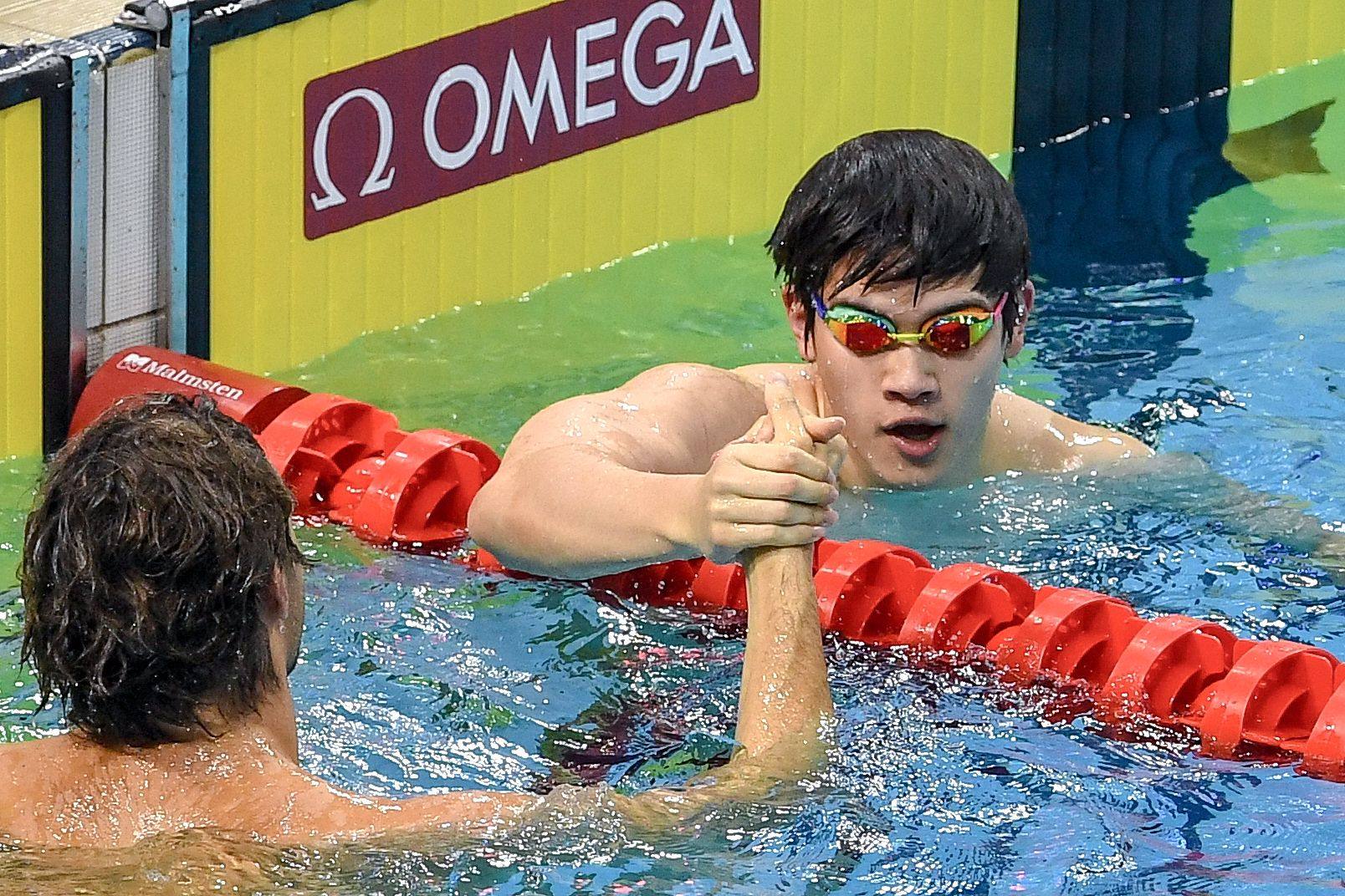 China’s Pan Zhanle (R) celebrates after winning the men’s 100m freestyle final event during the World Aquatics Swimming World Cup 2024 - Stop 3 in Singapore on November 1, 2024. (Photo by Roslan RAHMAN / AFP)