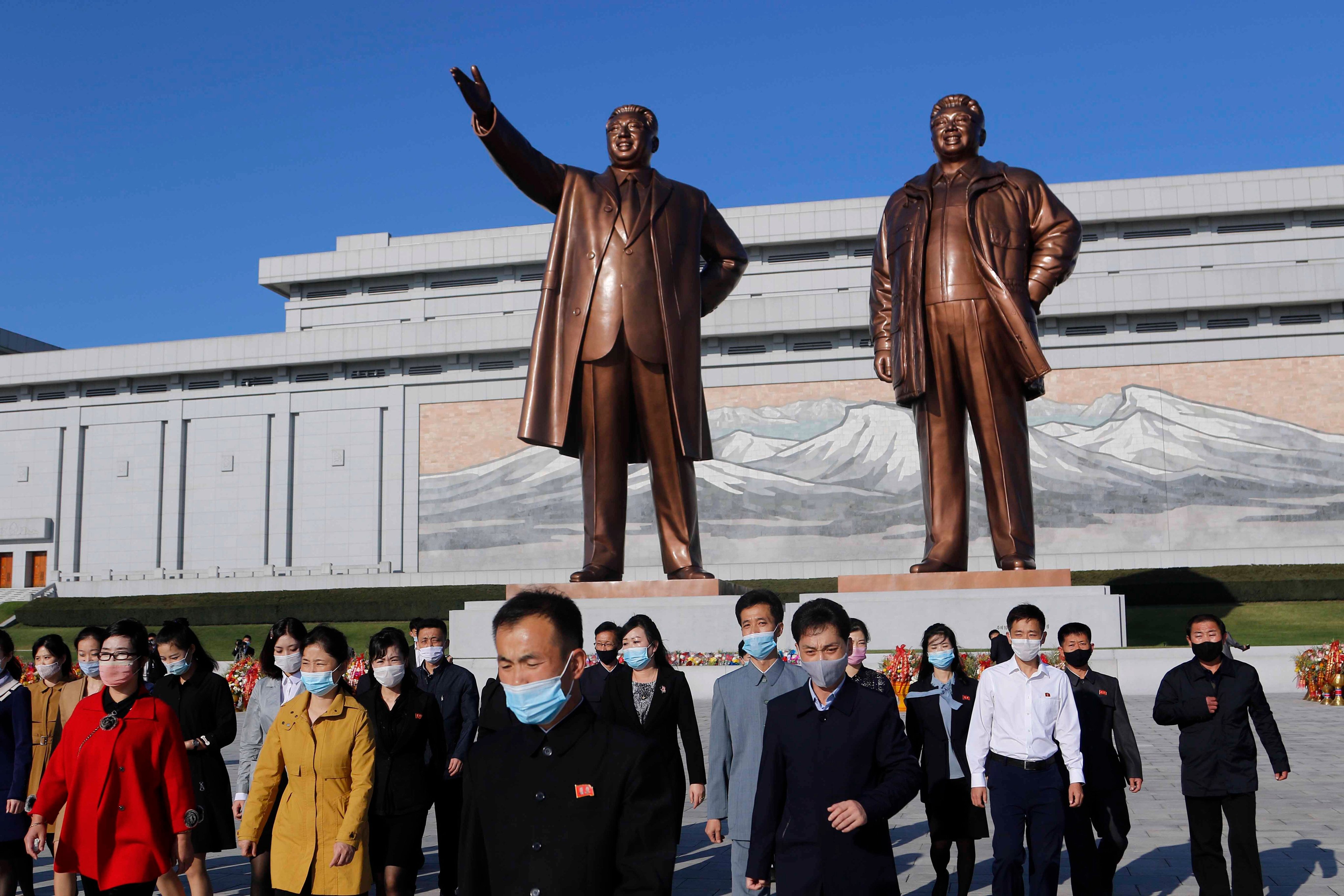 People visit the Mansu Hill to lay flowers to the bronze statues of former North Korean leaders Kim Il-sung and Kim Jong-il in Pyongyang. File photo: AP