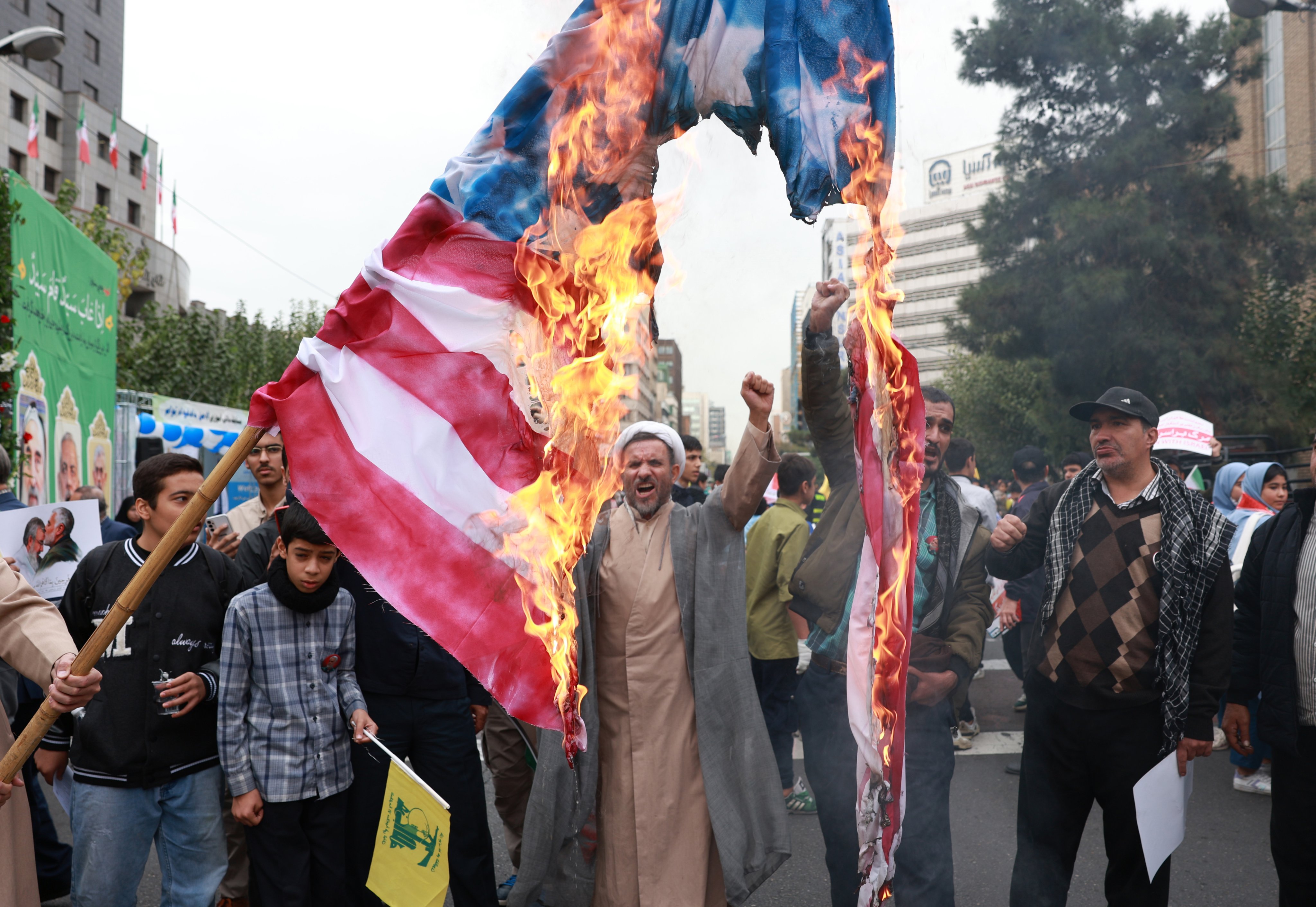 An Iranian cleric chants slogans as Iranians burn a US flag during an anti-US rally marking the 45th anniversary of the US Embassy takeover, in front of the former embassy building in Tehran, Iran, on Sunday. Photo: EPA/EFE