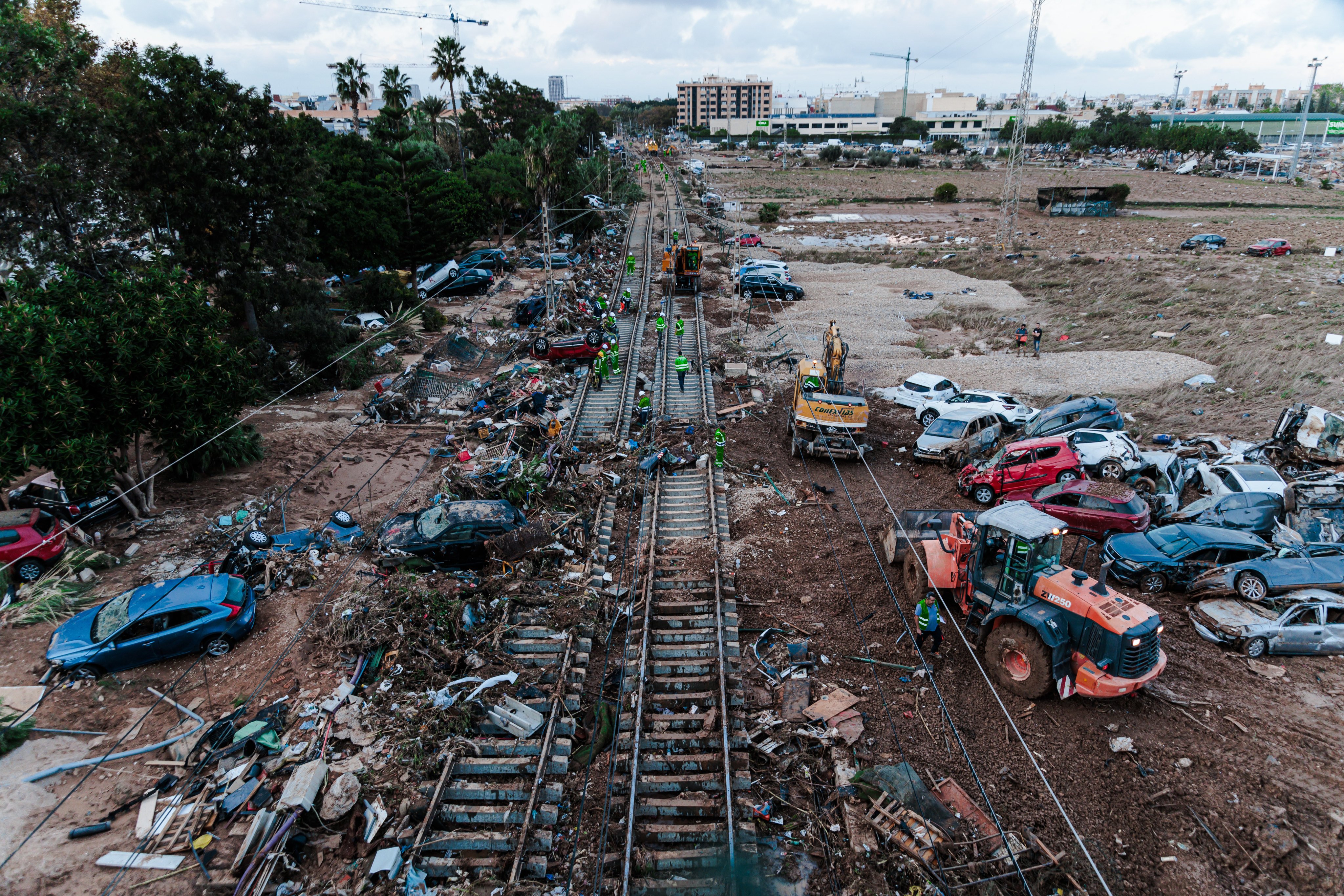 Several cars are piled up on the train tracks after heavy floods in in Alfafar in eastern Spain. At least 211 people were killed in Tuesday’s storms and floods in Spain’s southern and eastern regions, most of them in the Valencia region. Photo: dpa