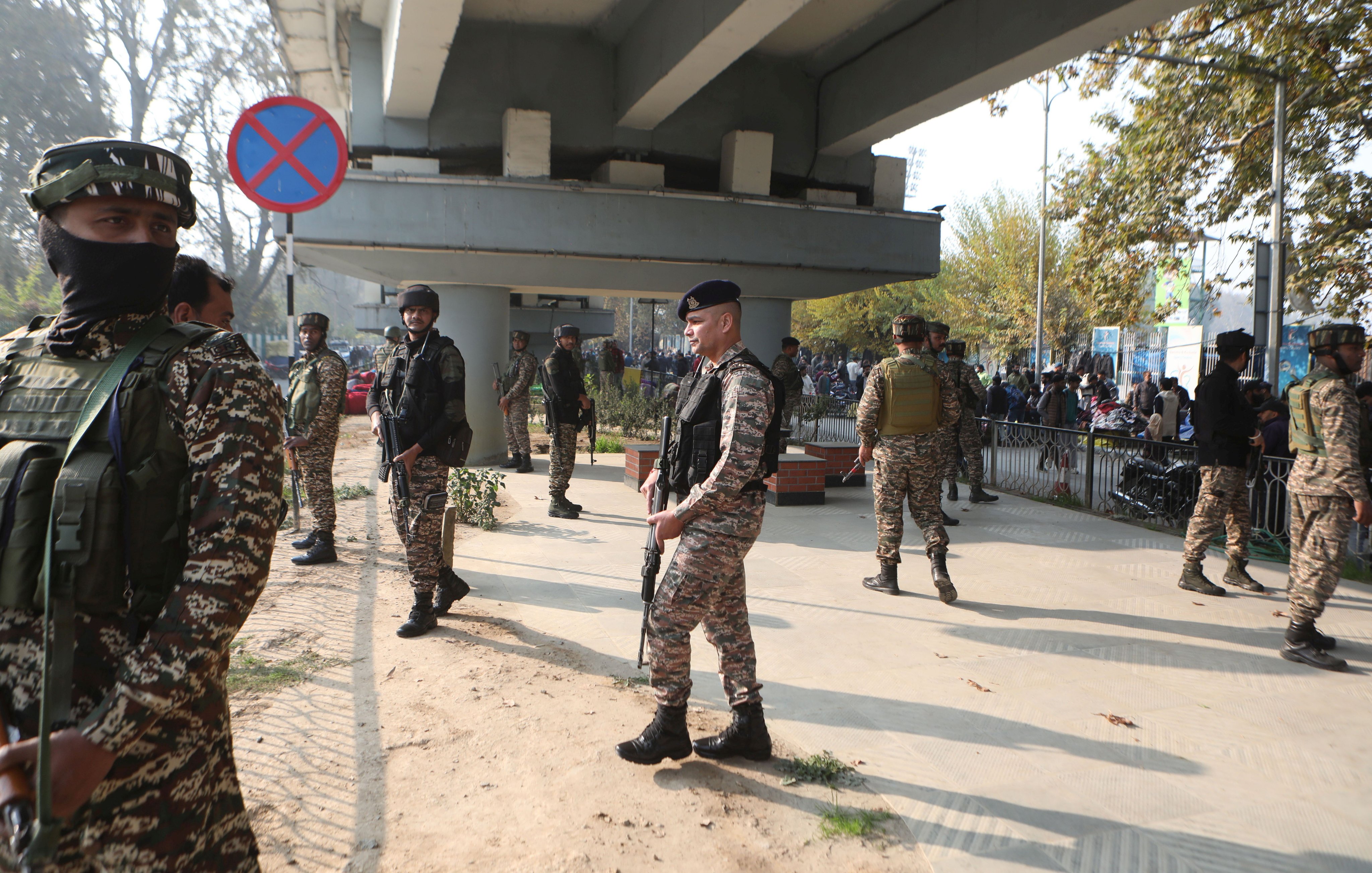 Indian police and paramilitary soldiers stand guard near the site of a grenade explosion in Srinagar, Kashmir on Sunday. Photo: EPA-EFE