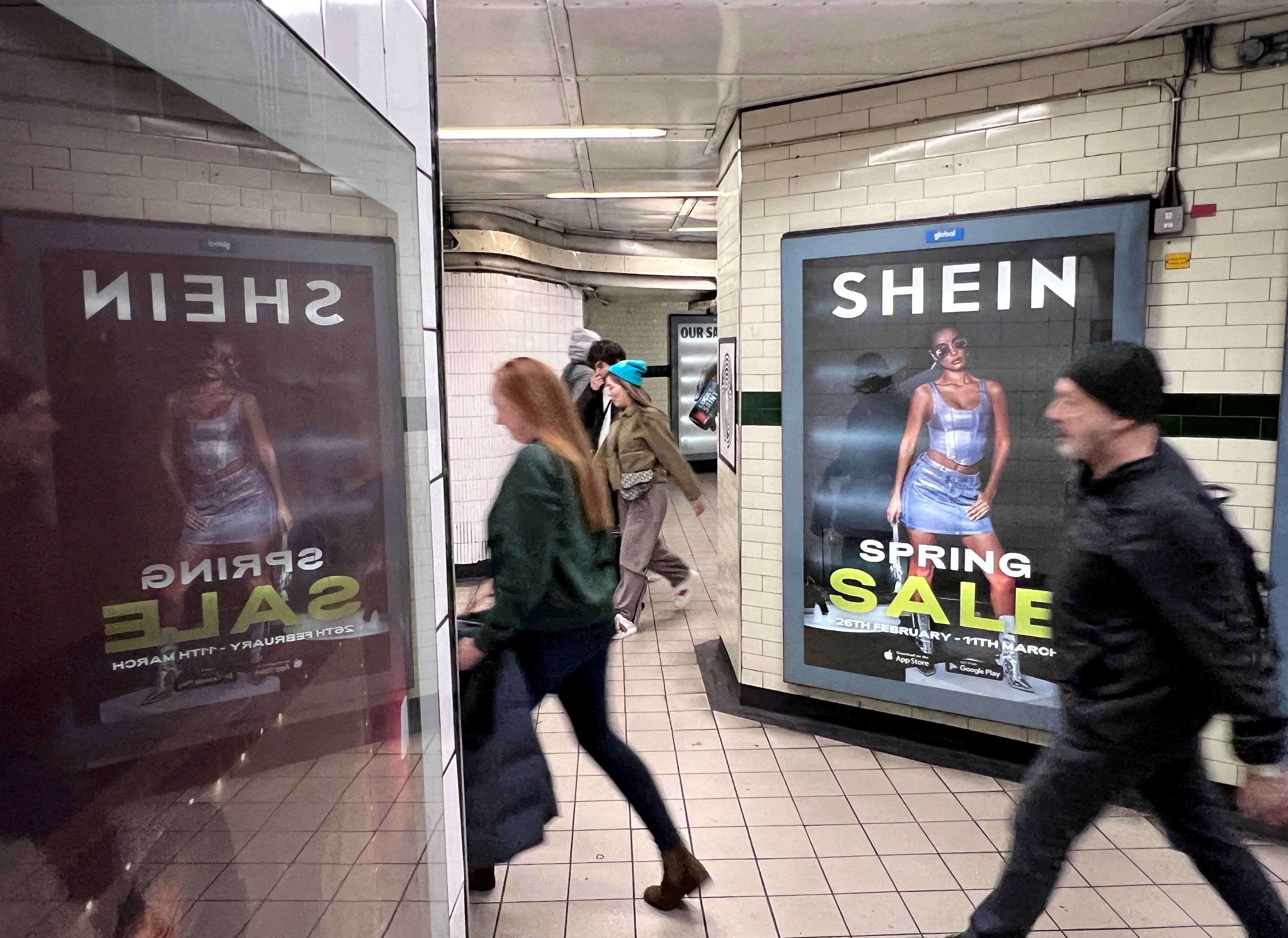 People walk past an ad for online retailer Shein in London, UK. Photo: Reuters