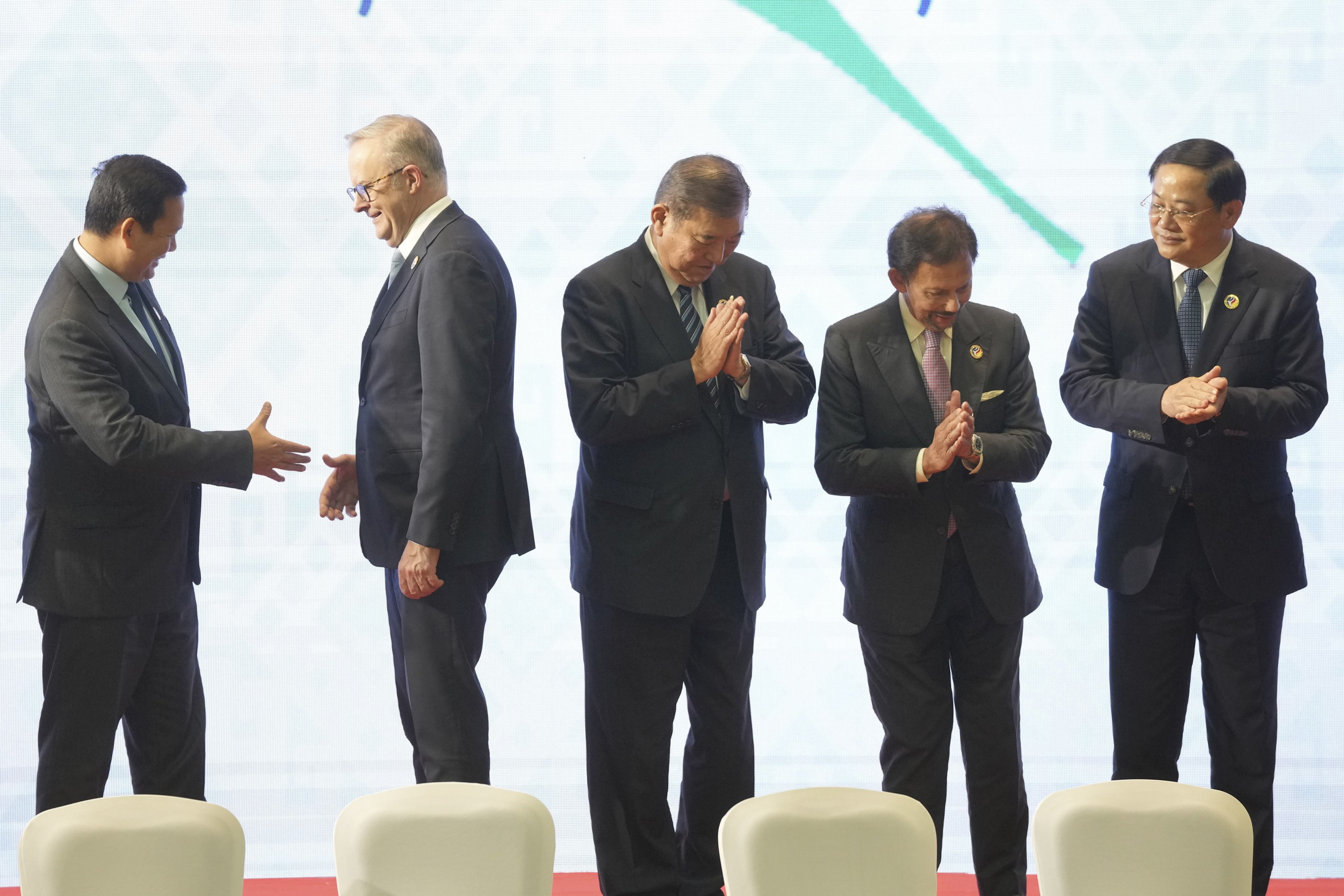 Cambodian Prime Minister Hun Manet (from left), Australian Prime Minister Anthony Albanese, Japanese Prime Minister Shigeru Ishiba, Brunei Sultan Hassanal Bolkiah, and Laotian Prime Minister Sonexay Siphandone applaud after a group photo during the 2nd Asia Zero Emission Community Leaders Meeting on the sidelines of the Asean Summit in Vientiane, Laos, on October 11. Photo: AP