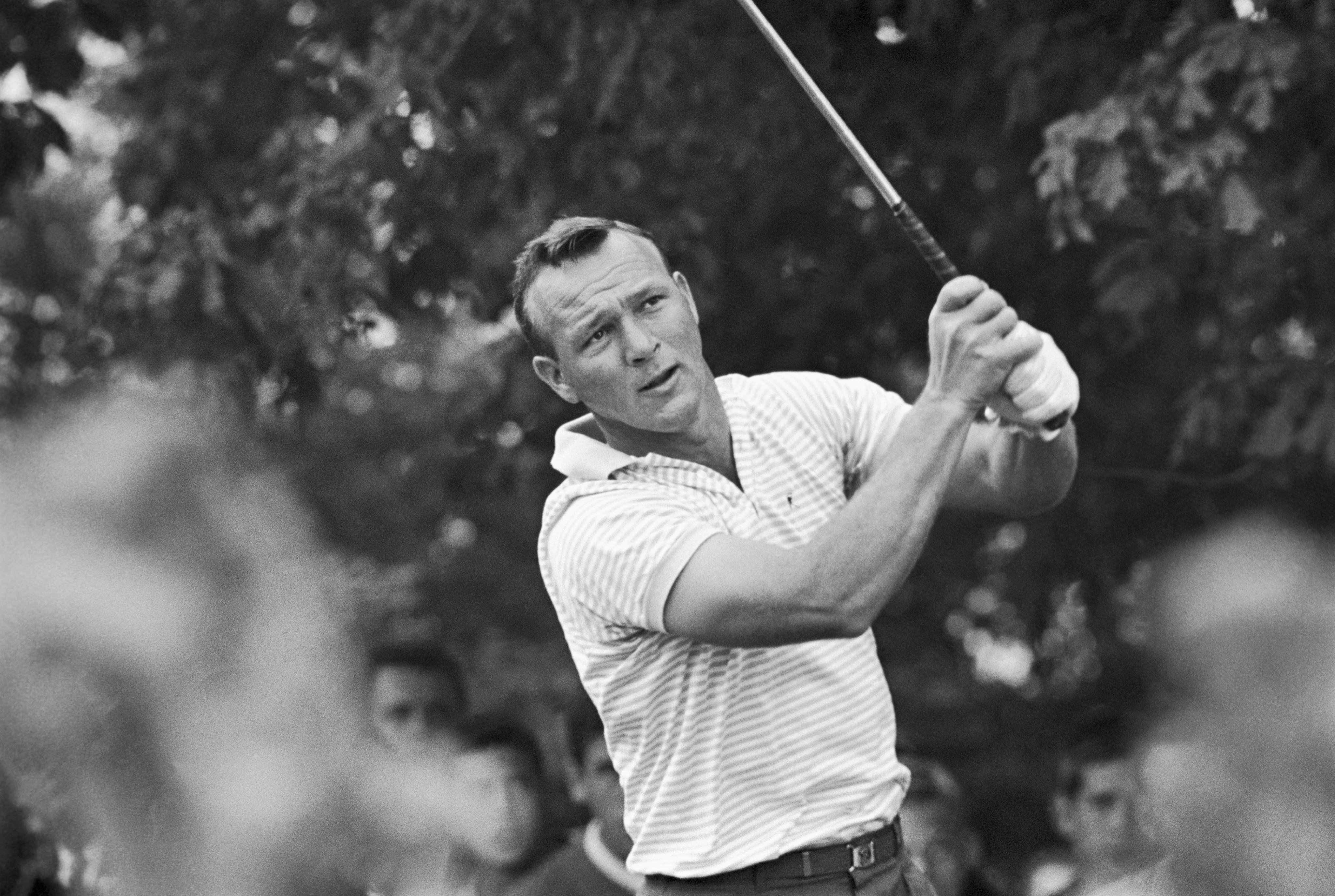 Arnold Palmer tees off on the 10th hole with a good margin of lead over Phil Rodgers and Jacky Cupit, in 1963. Palmer went on to win the World Series Playoff berth by defeating Rodgers by 5 strokes and Cupit by 7. Photo: Getty Images