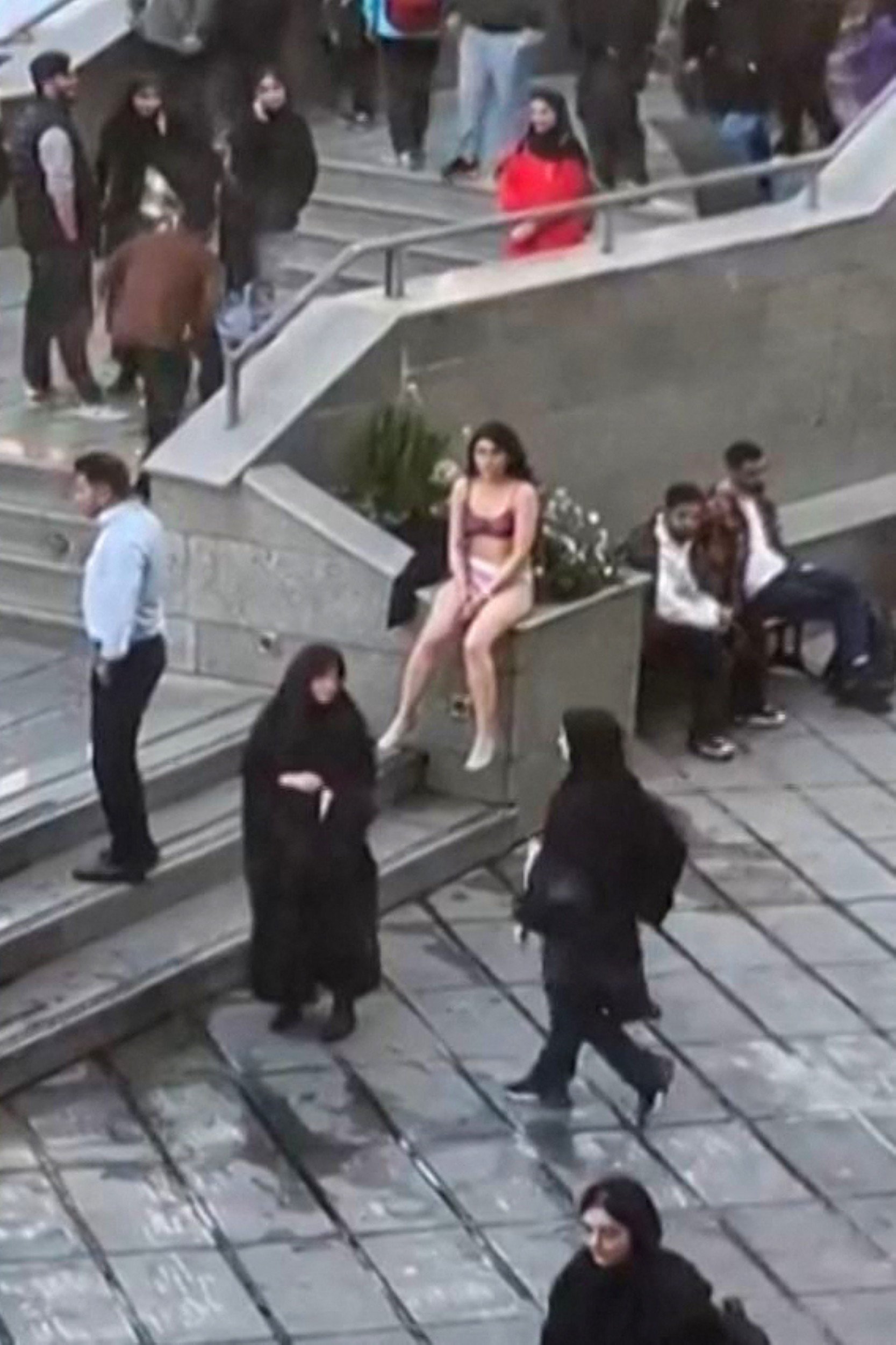 Footage widely shared on social media shows a female student in her underwear outside Tehran’s Islamic Azad University. Photo: UGC via AFP