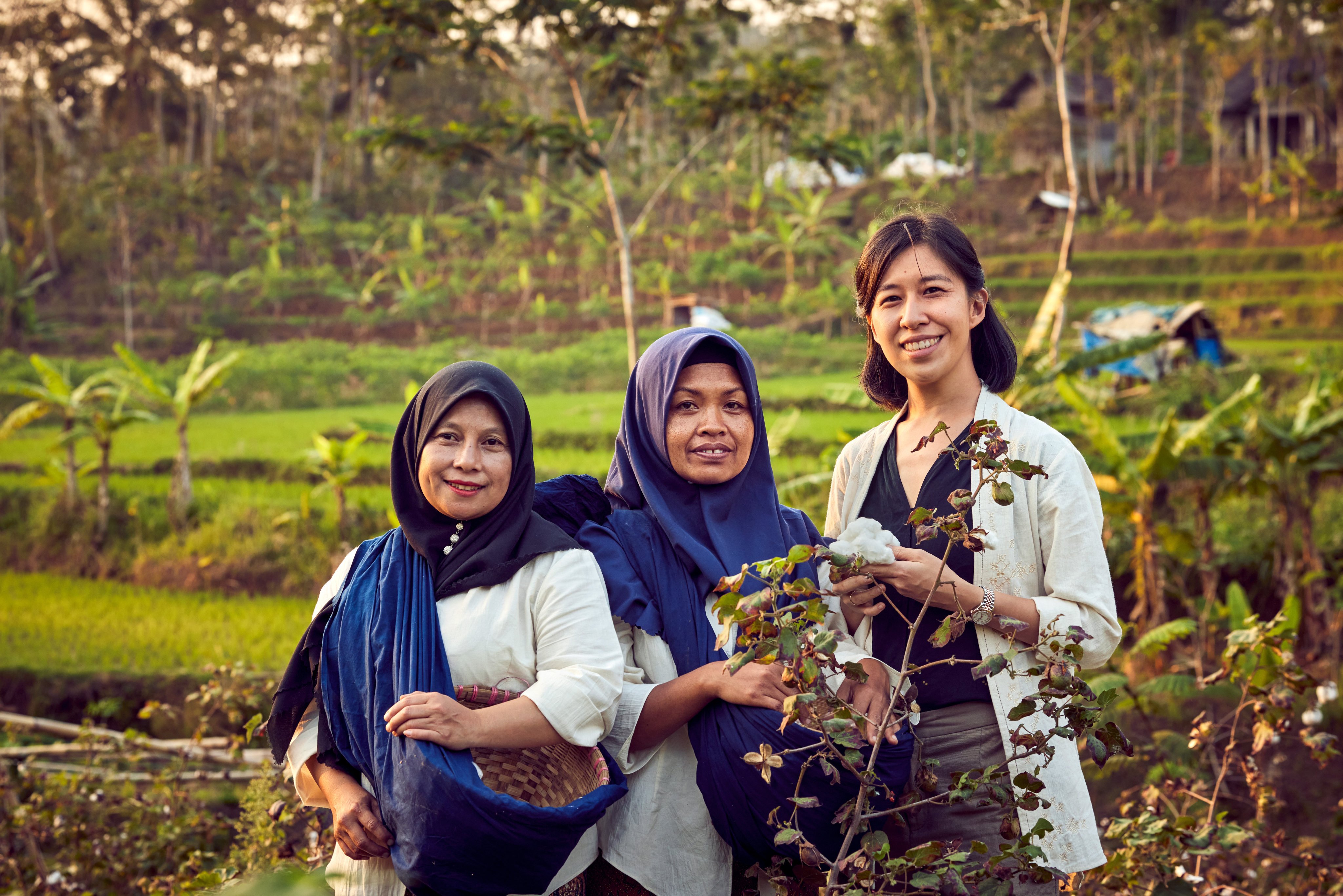 Rolex Awards for Enterprise laureate of 2023 and founder of SukkhaCitta, Denica Riadini-Flesch, holding cotton harvested on a farm near Central Java, Indonesia, by Ibu Tun and Ibu Dair, also pictured. The cotton will be used to make high-quality, traditionally crafted clothes, making SukkhaCitta a true farm-to-closet company. Photos: Handout