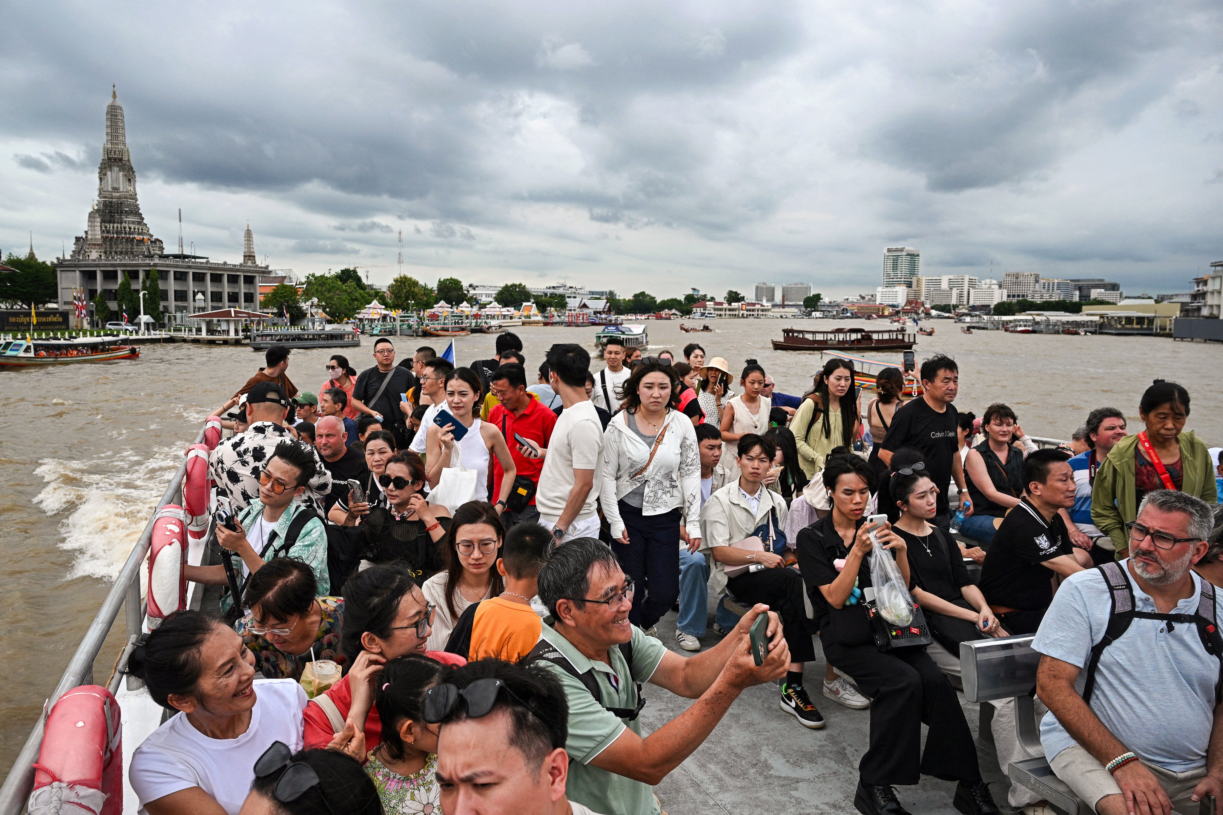 People take a tourist boat on the Chao Praya River in Bangkok. Photo: AFP